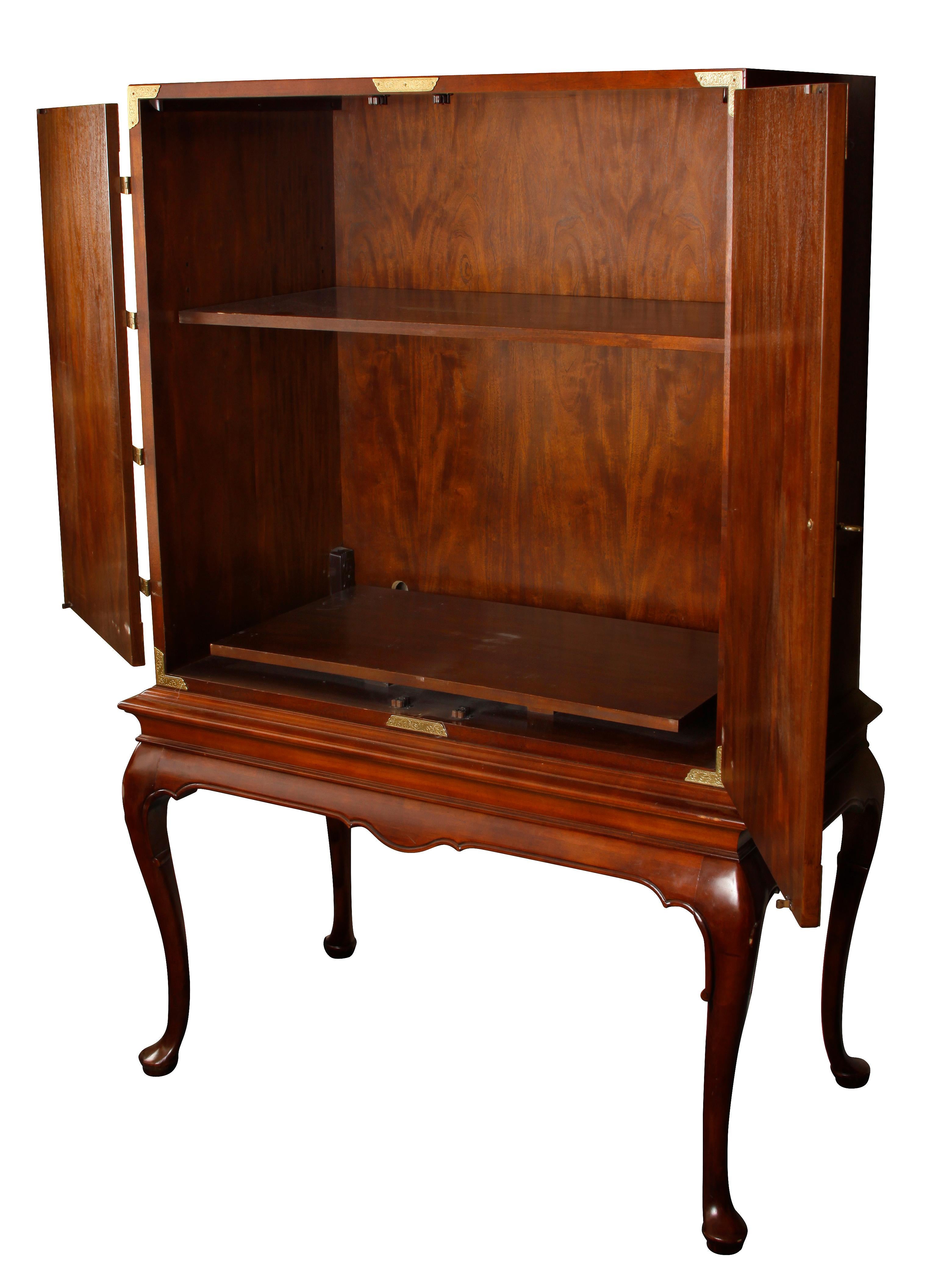 English and Asian influenced media cabinet with two-door panels. Opens to interior with two shelves and drilled in back for wiring. Cabinet sits on cabriole legs.