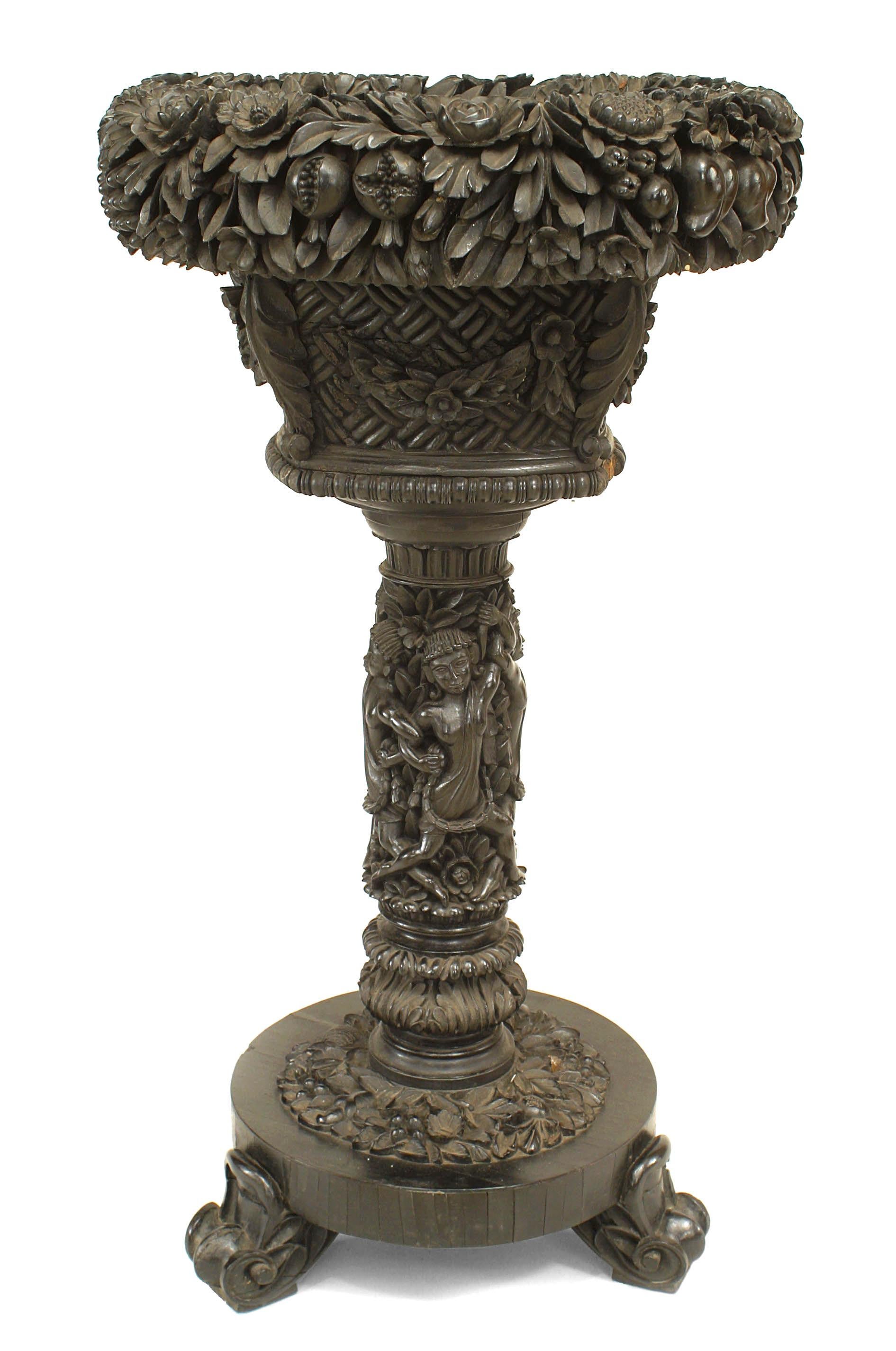 English Anglo Indian floral carved ebony fernery with circular top and pedestal base. (19th Cent)
