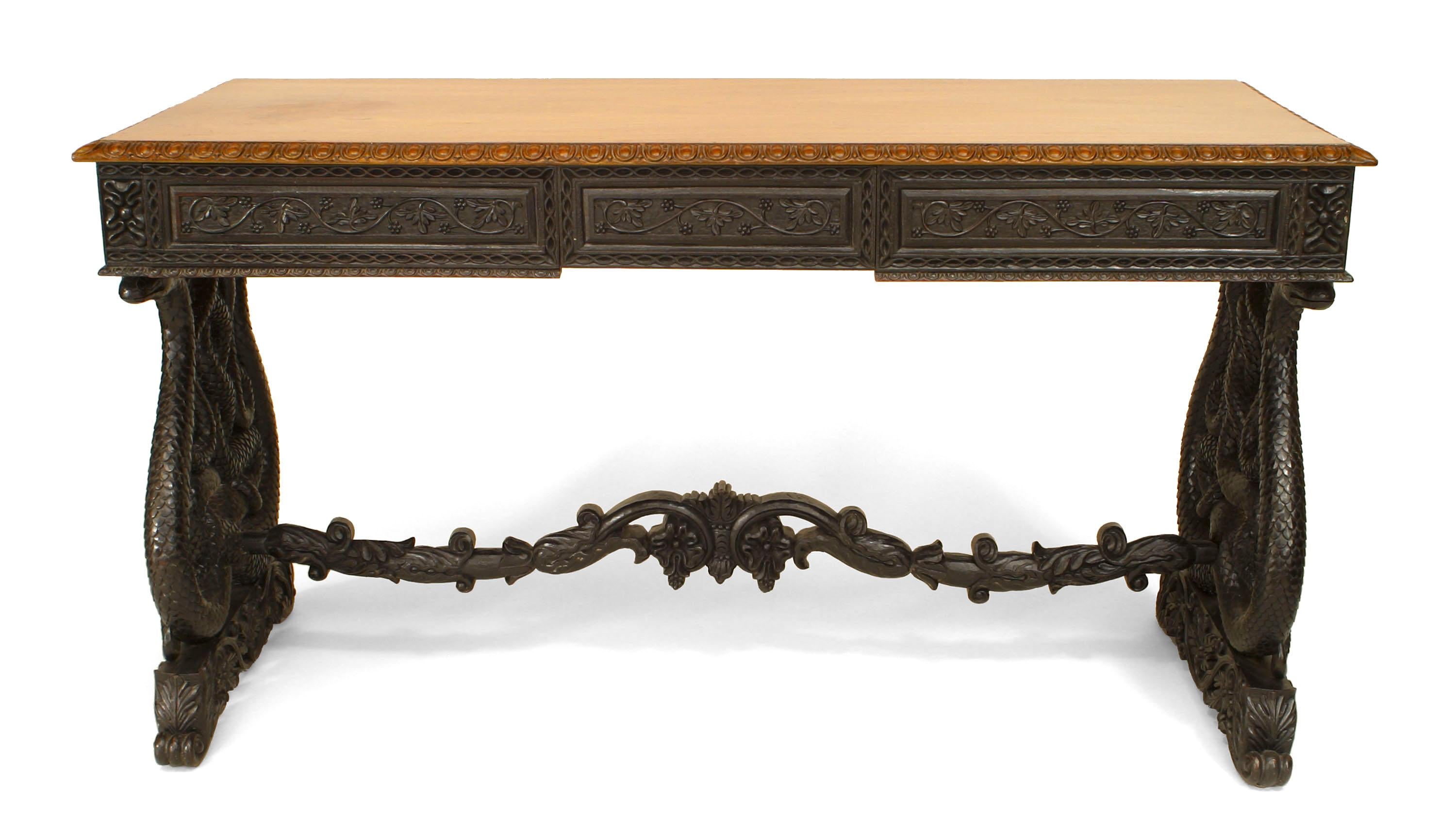 Mid-19th century English Anglo-Indian ebonized rosewood and padouk writing table with 3 frieze drawers over entwined serpent trestle legs joined by a stretcher. (possibly Ceylonese).