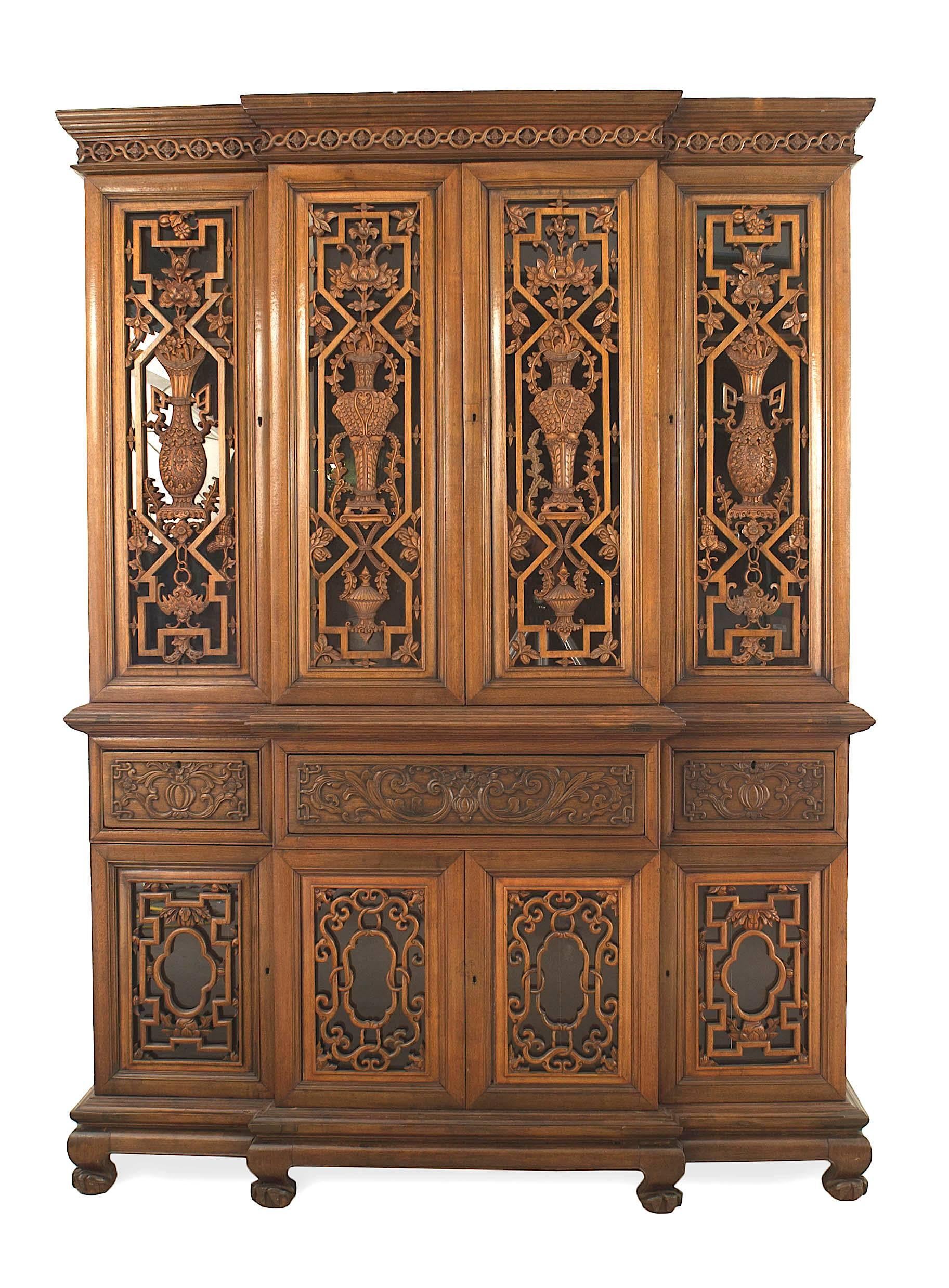 English Anglo-Indian (19th Century) carved teakwood breakfront with an upper section having 4 doors over a bottom section with 4 drawers and 4 doors with filigree floral & geometric design (Straits Settlements)
