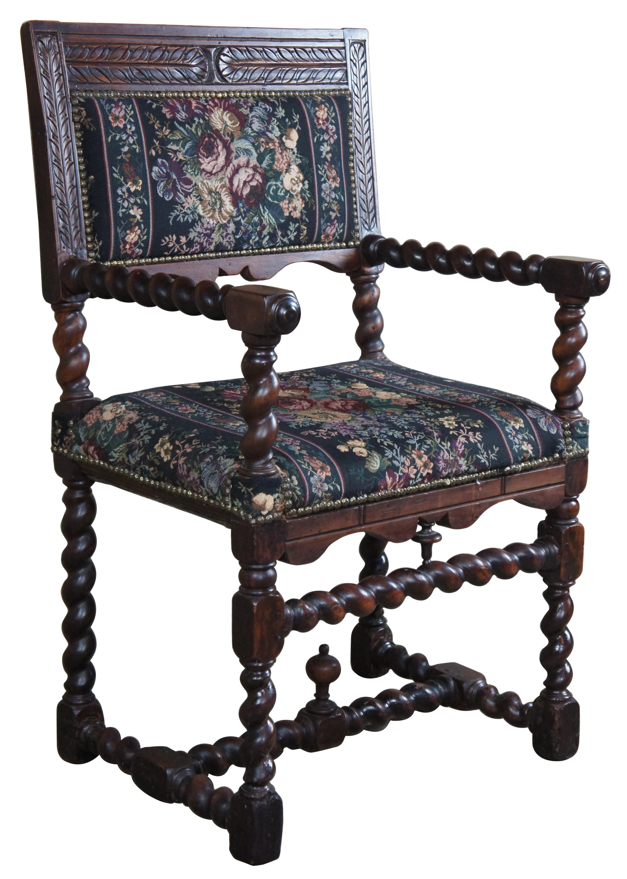Mid-19th century English oak throne chair. Features Spanish inspired carvings along the back, serpentine aprons, barley twist supports, trestle base with upward facing finial, floral upholstered seat and back with nailhead trim.
 