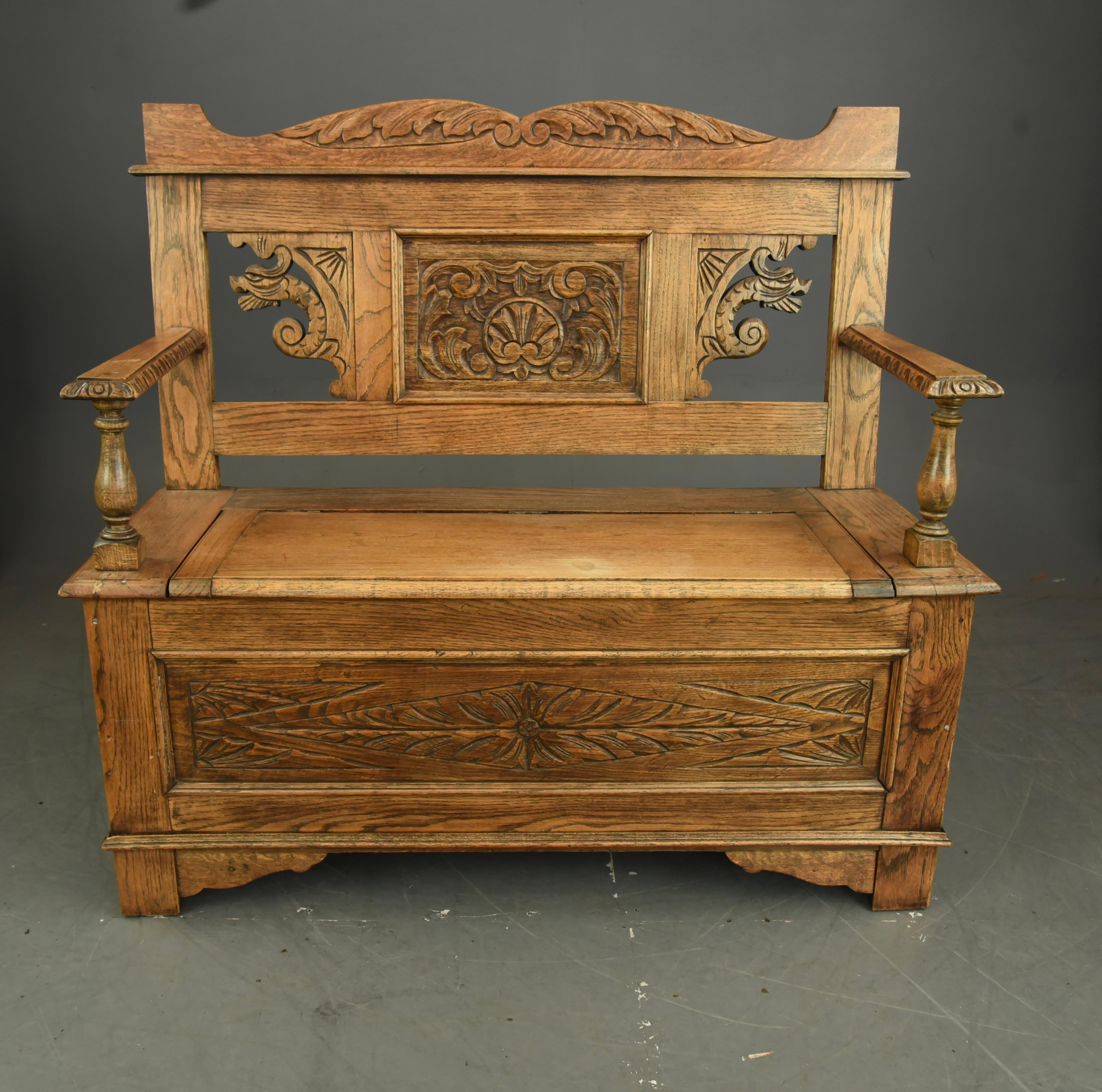 Good quality light oak Victorian monks bench hall bench ,with quality carving through out very good condition in light oak with waxed finish ,The lift up seat provides ideal storage for shoes, boots . 
A wonderful bench that would fit into a modern