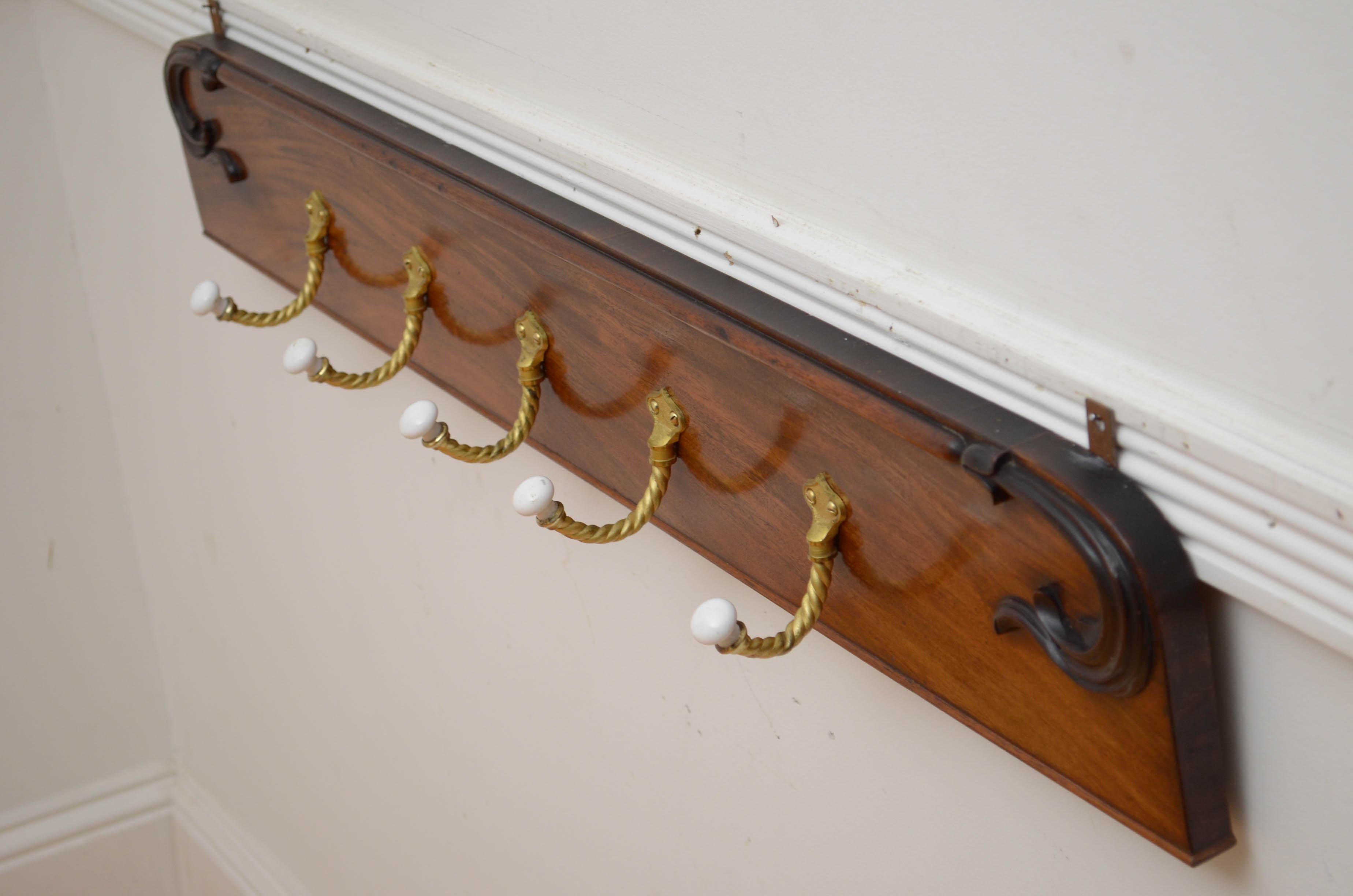 P0300 Very attractive set of five twisted rope and ceramic coat hooks now on William IV figured mahogany backing with carved foliage motifs to each end. Fitted with wall fixing and ready to place at home. c1850
Attractive and very practical coat