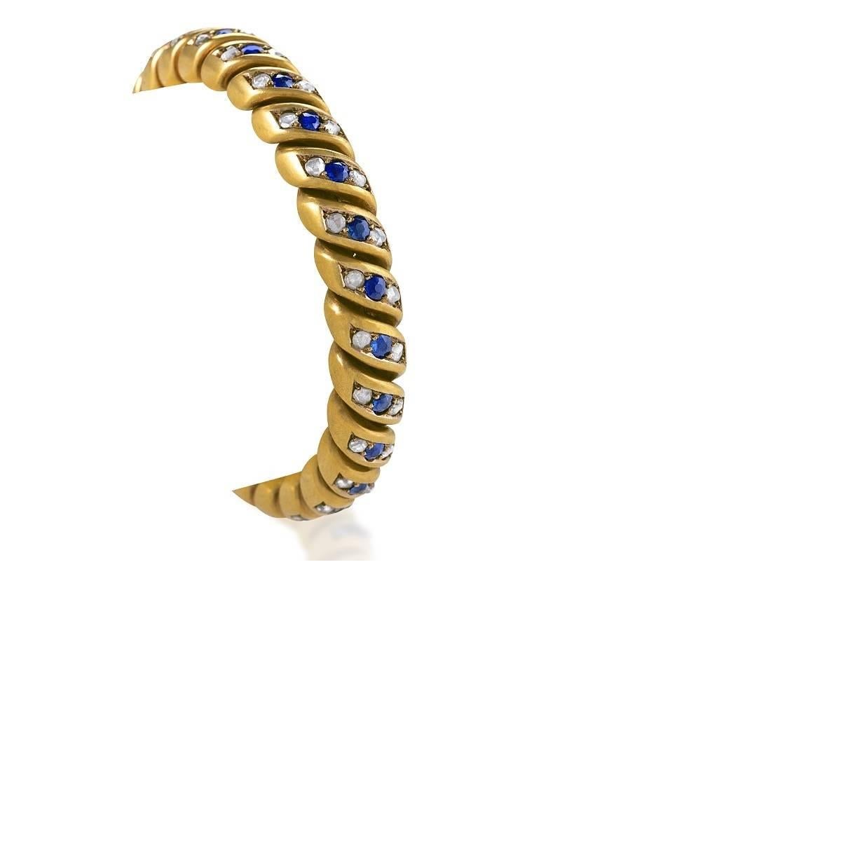 An English Antique 18 karat bloomed gold bracelet with sapphires and diamonds. The bracelet has 25 old round cut sapphires with an approximate total weight of 2.50 carats, and 50 rose cut diamonds with an approximate total weight of 2.50 carats. The