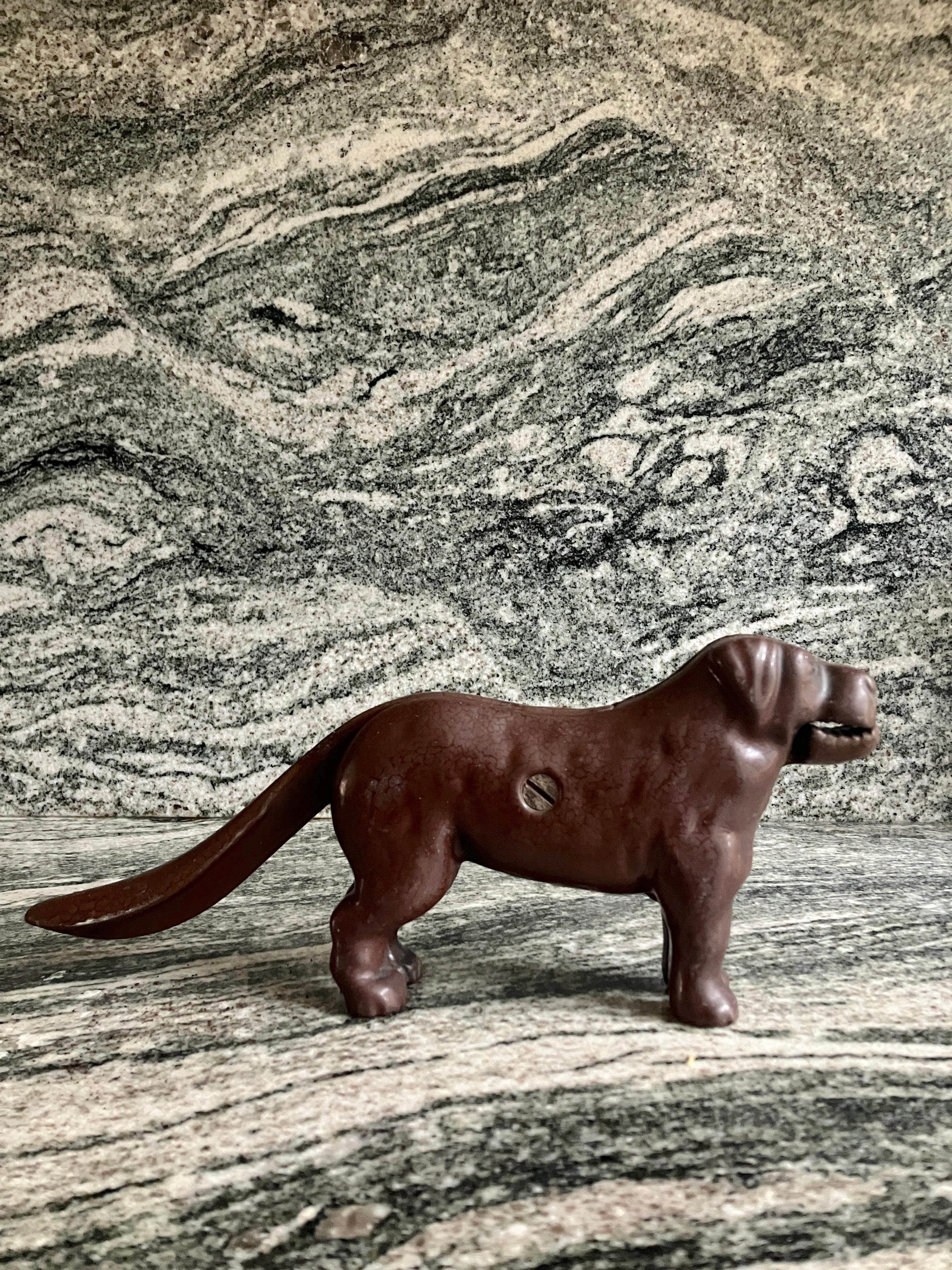 A gorgeous late Victorian cast iron dog nutcracker from England. The antique nutcracker comes in a handsome dog form.
This is a very heavy item, made of cast iron and enameled brown. The dog would look great as a decorative item, too. 

In good