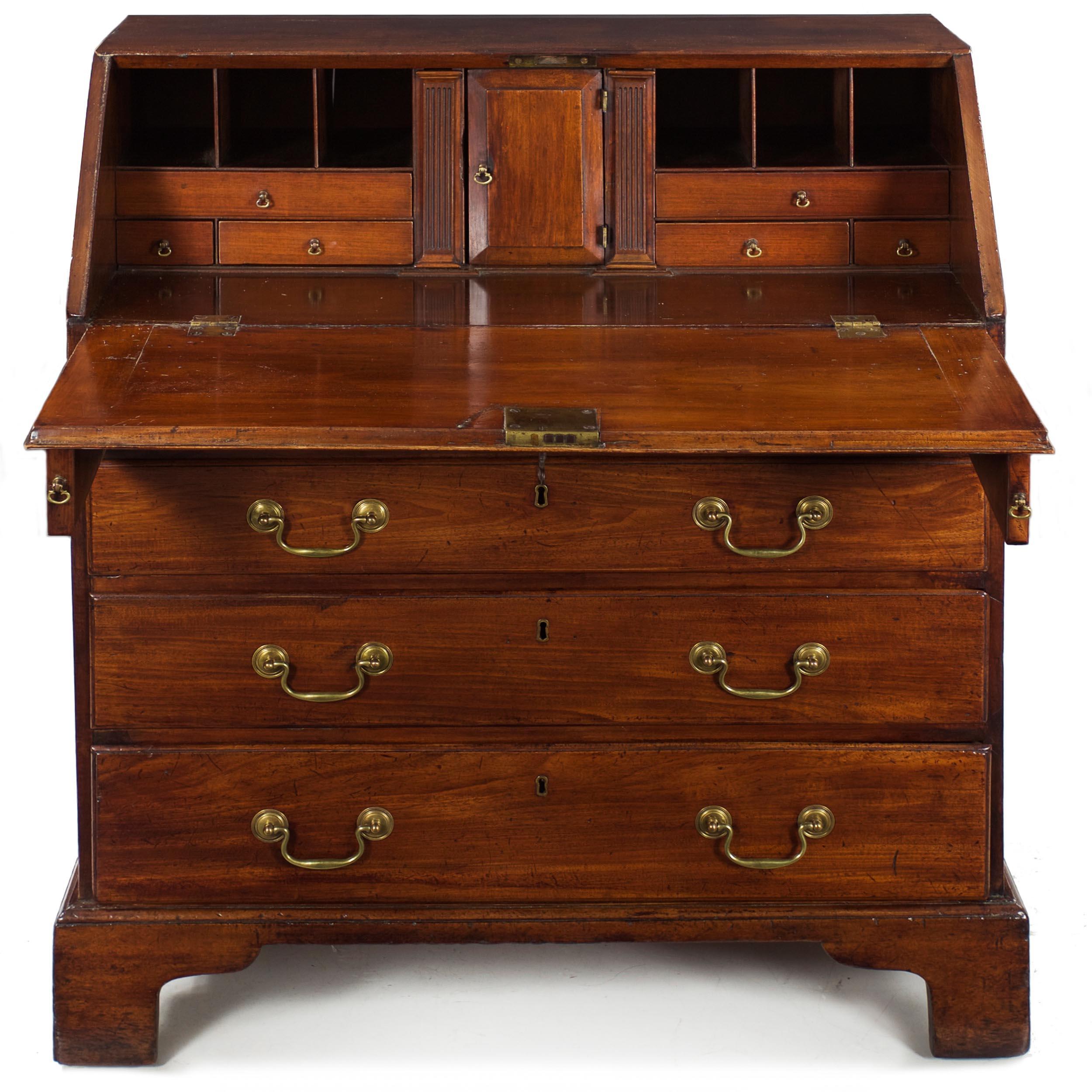 A wonderful George III period slant-front desk executed in dense well-figured mahogany primary woods, it retains a fine overall surface patina under old shellac that has developed a silky texture from years of handling and waxing. The writing