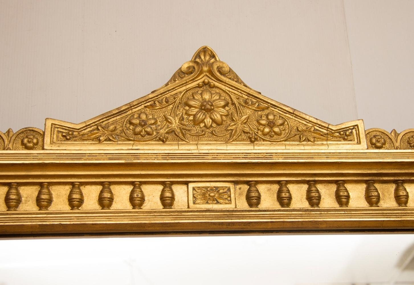 English antique gilded overmantel mirror with original glass mirror plate with one or two very small marks. No foxing. This is original silver nitrate mirror plate not mercury backed.
Structural restorations are carried out using traditional