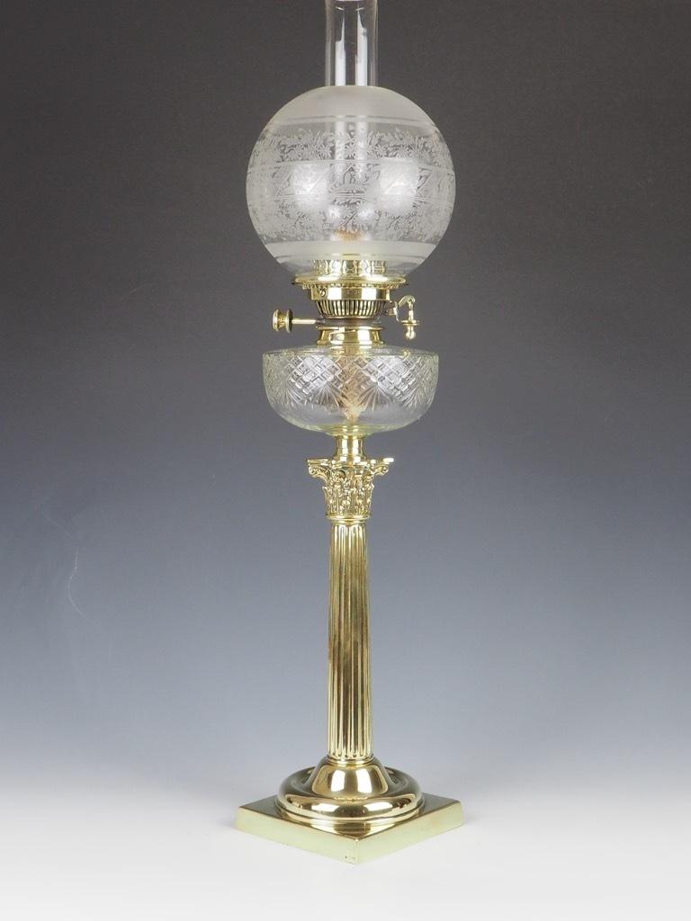 Exquisite English Antique Brass Oil Lamp, crafted by the esteemed Hinks and Sons of Birmingham, is a remarkable representation of 19th-century Victorian design.

Standing tall with a grand Corinthian column, this lamp features a superb cut glass