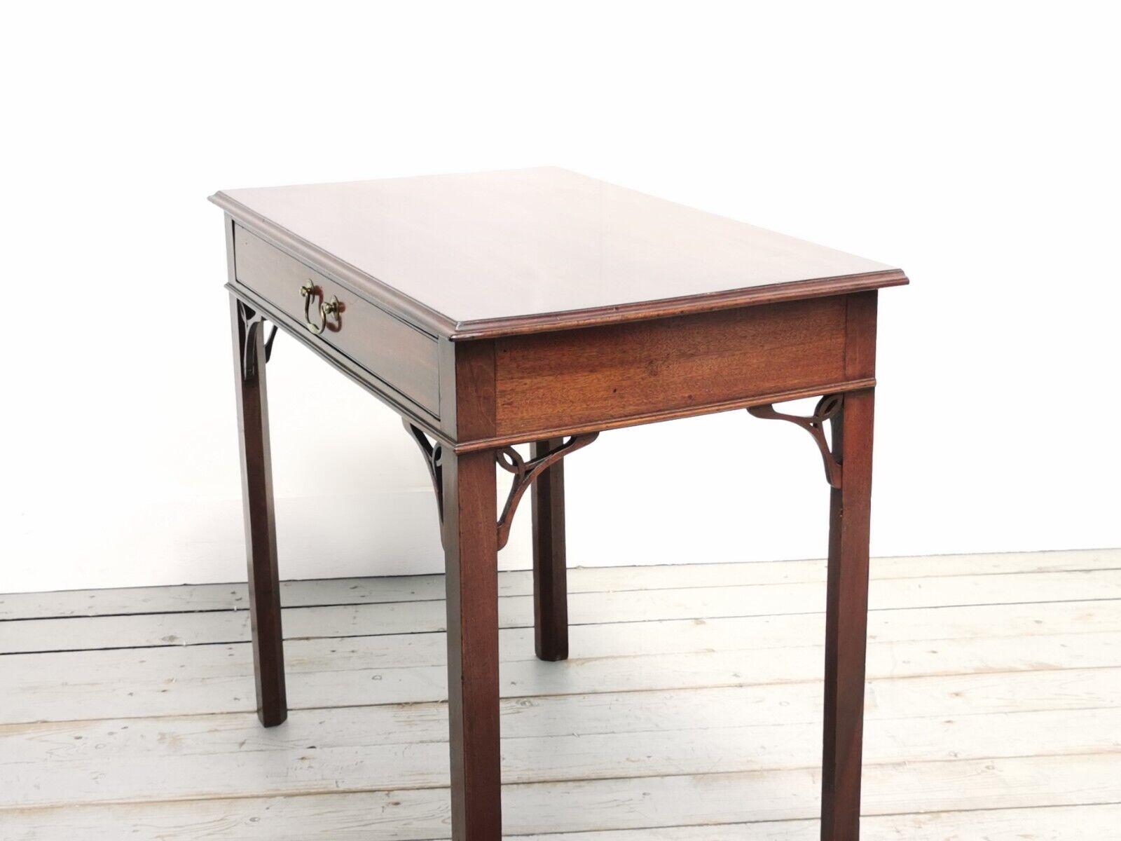 Antique side table

A 19th century English compact side table or writing desk.

Mahogany side table with single frieze drawer with a brass swan neck handle, on inner chamfered square supports with open fretwork corner detail.

Dimensions