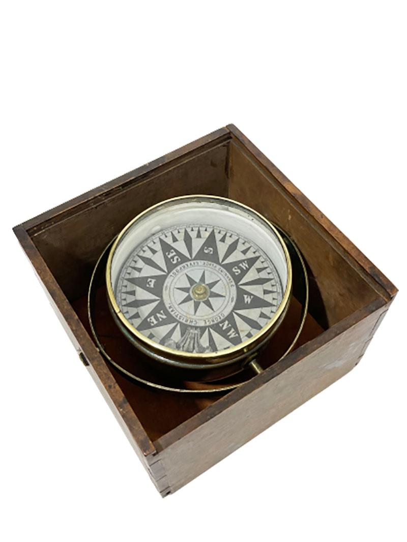 English antique nautical dry compass, by George Christian, Liverpool

Antique late 19th century dry card compass housed in a brass tub that is suspended by gimbales in a wooden dovetail box with a sliding lid. 
The dry card is a printed card by