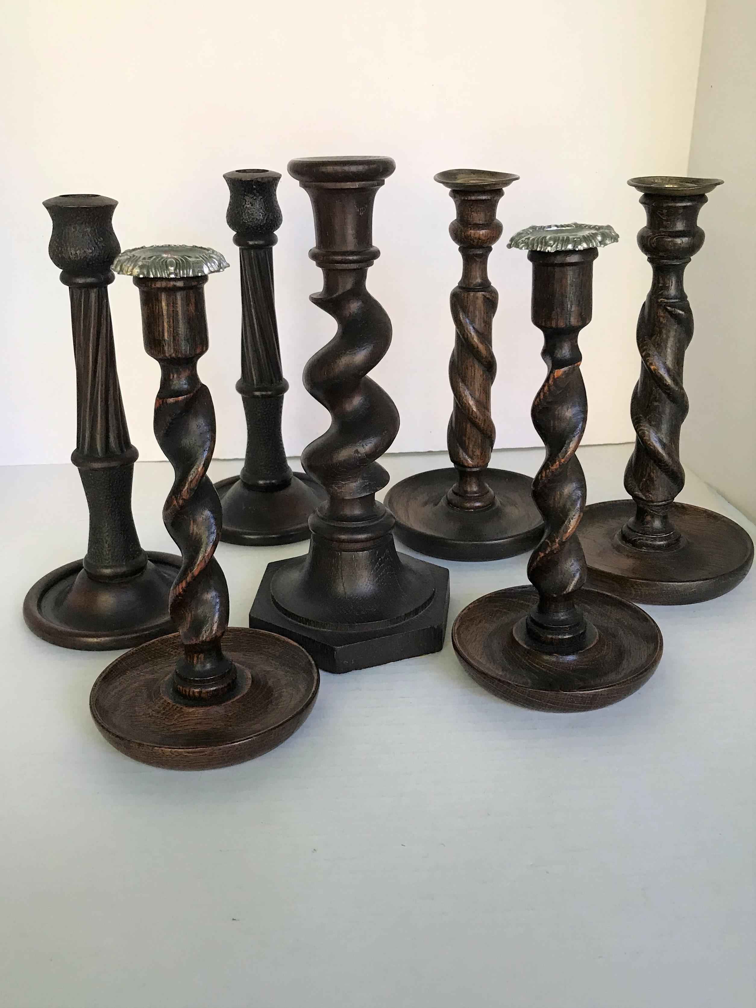 Grouping of Victorian and Edwardian (possibily earlier) Era Candlesticks set of 7. Set contains: a single Oak Barley Twist stick with a 6-sided base, one pair with twisting tendril on cydrindical post with brass bobeche, one pair of Oak Barley Twist