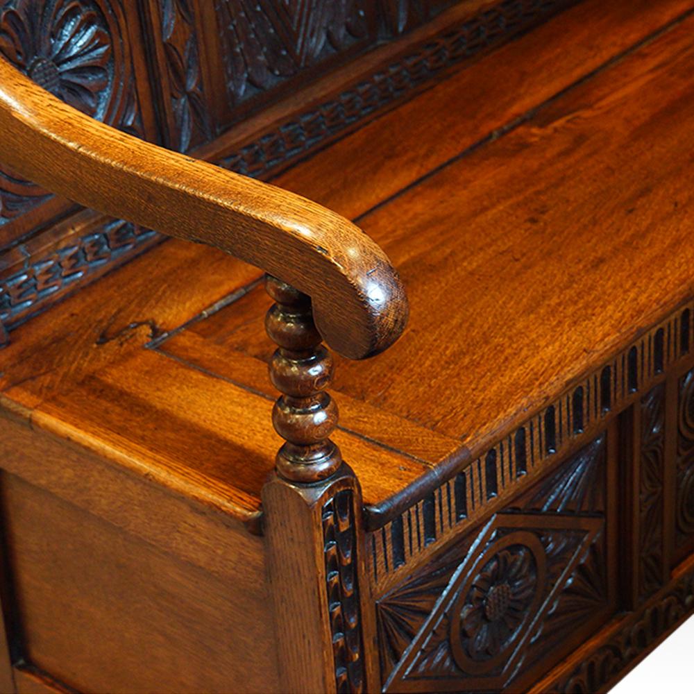 Antique carved oak settle
This Antique carved oak settle was made in the 19th century circa 1860.
The high back with 4 carved panels at the top and 4 larger carved panels below.
The box base with its lifting seat lid to reveal full storage