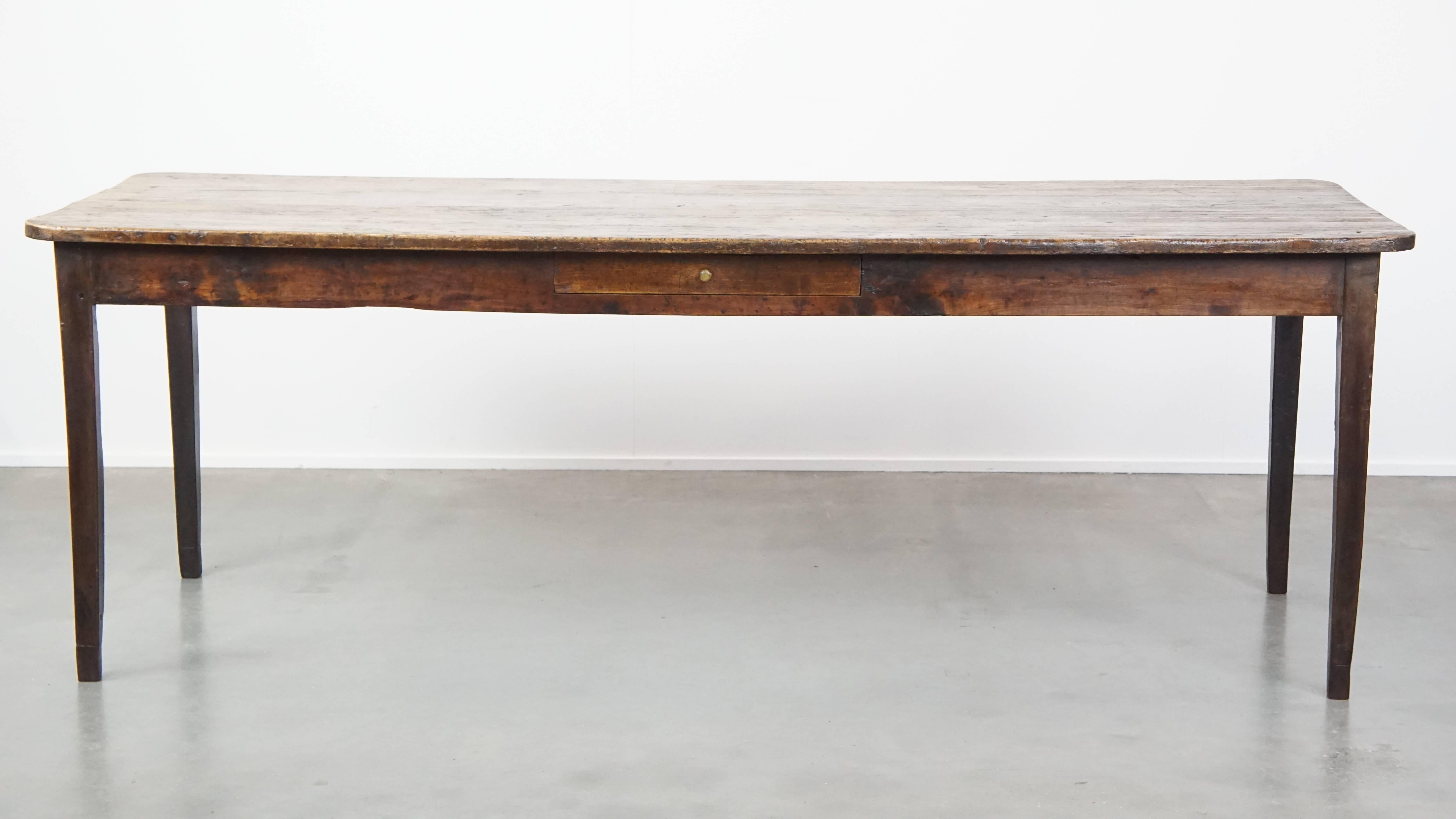 Offered here is this very beautiful and characterful English antique pinewood country dining table with a uniquely lovely patina. In our opinion, this English antique pinewood dining table is a must-have for any interior. It features stunning colors