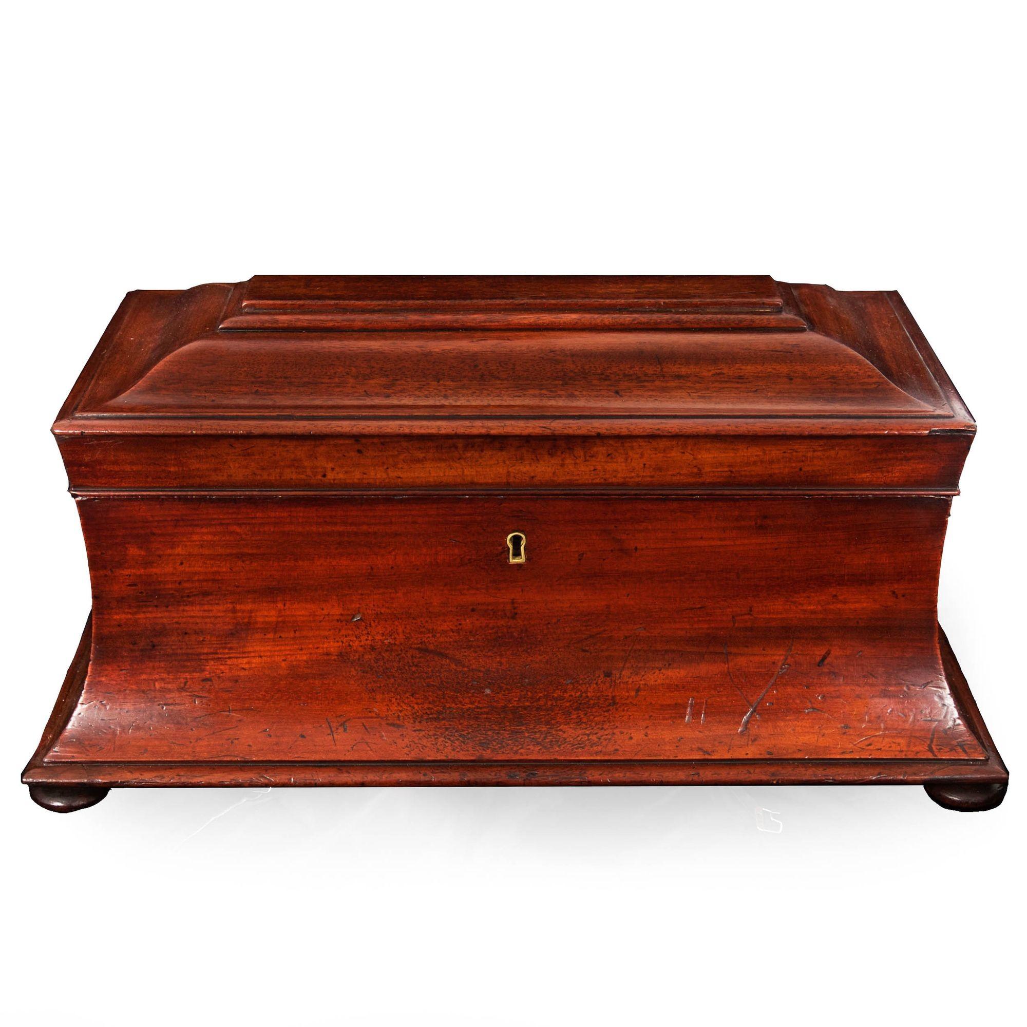 A very fine Regency period mahogany tea caddy of sarcophagus form, it features a wonderful early surface that is rich with patina: oxidized old finish in crevices and edges, the ruby hues of the mahogany coming through where it has been handled