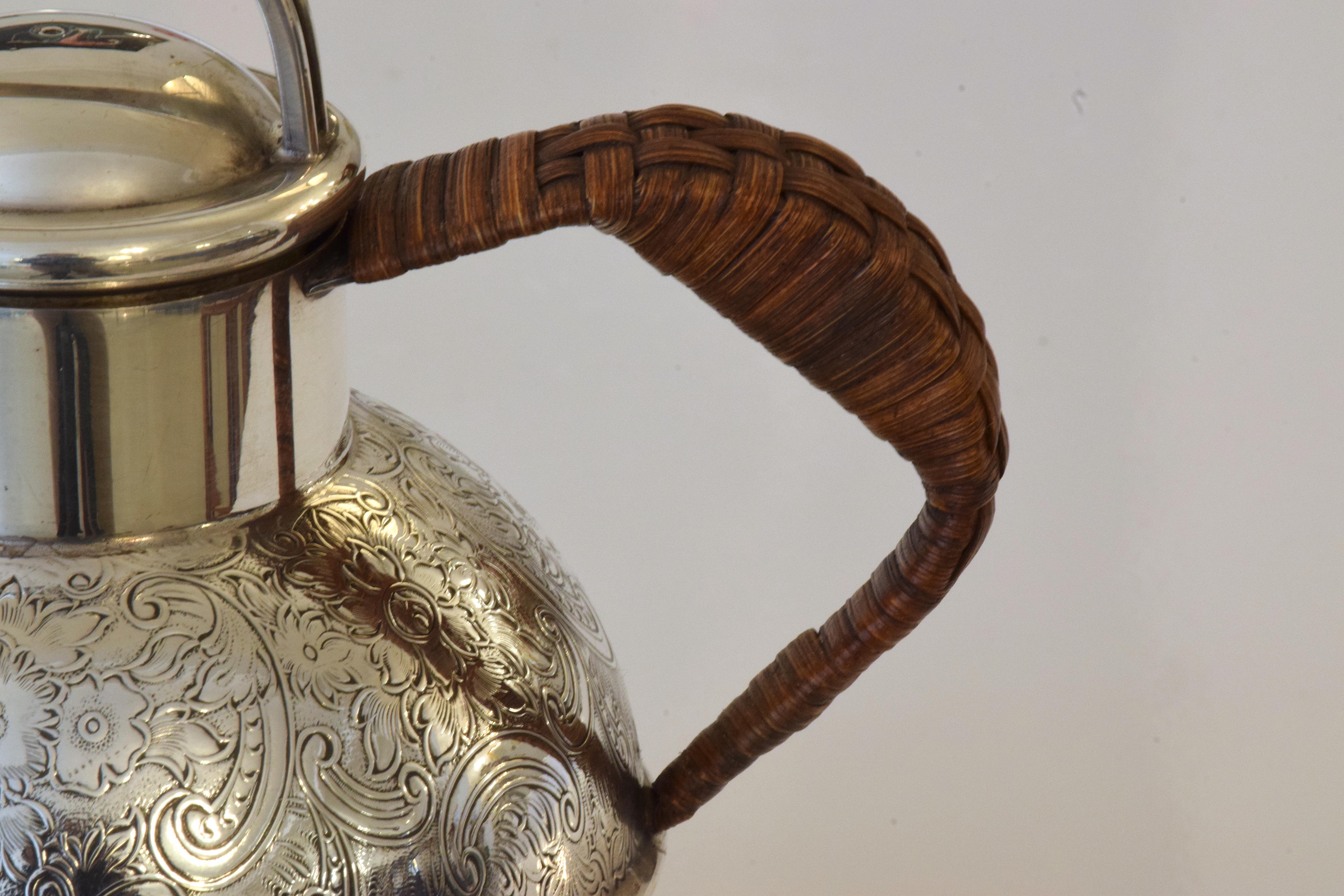 A sterling silver teapot from the early 20th century by Bailey Banks & Biddle. A small design initially created for boats composed of engravings and a plated wooden handle, makes a great decorative piece.