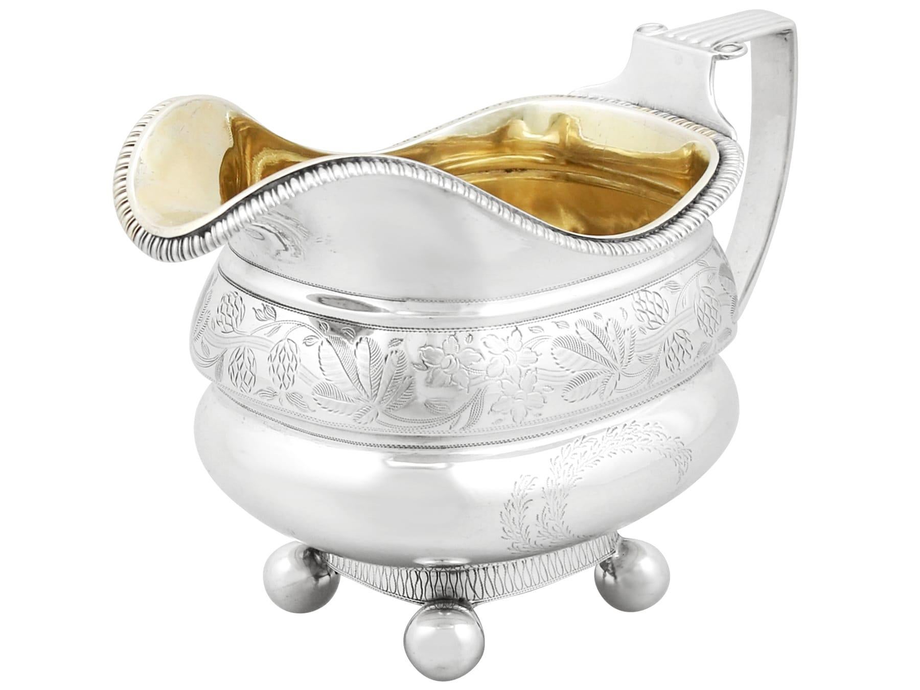 An exceptional, fine and impressive antique English sterling silver cream jug; an addition to our silver tea ware collection.

This exceptional antique silver cream jug has a rounded helmet shaped form.

The lower portion of the body is