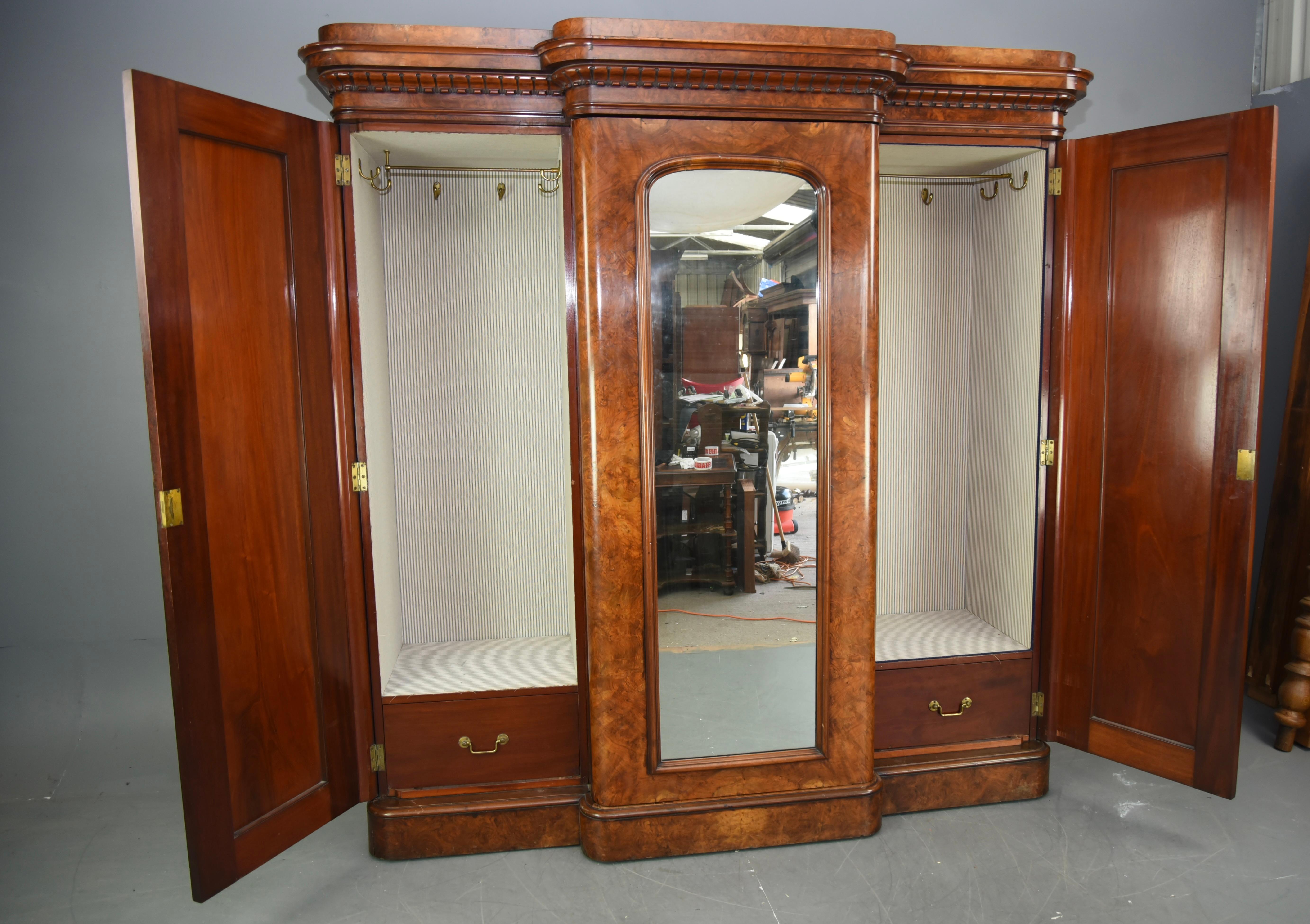 A Superb Victorian Burr walnut triple wardrobe circa 1860.
The wardrobe has fantastic figuring and colour of the finest quality.
The wonderful rounded corner cornice has very fine carved detailing that is only seen on the best Antique furniture