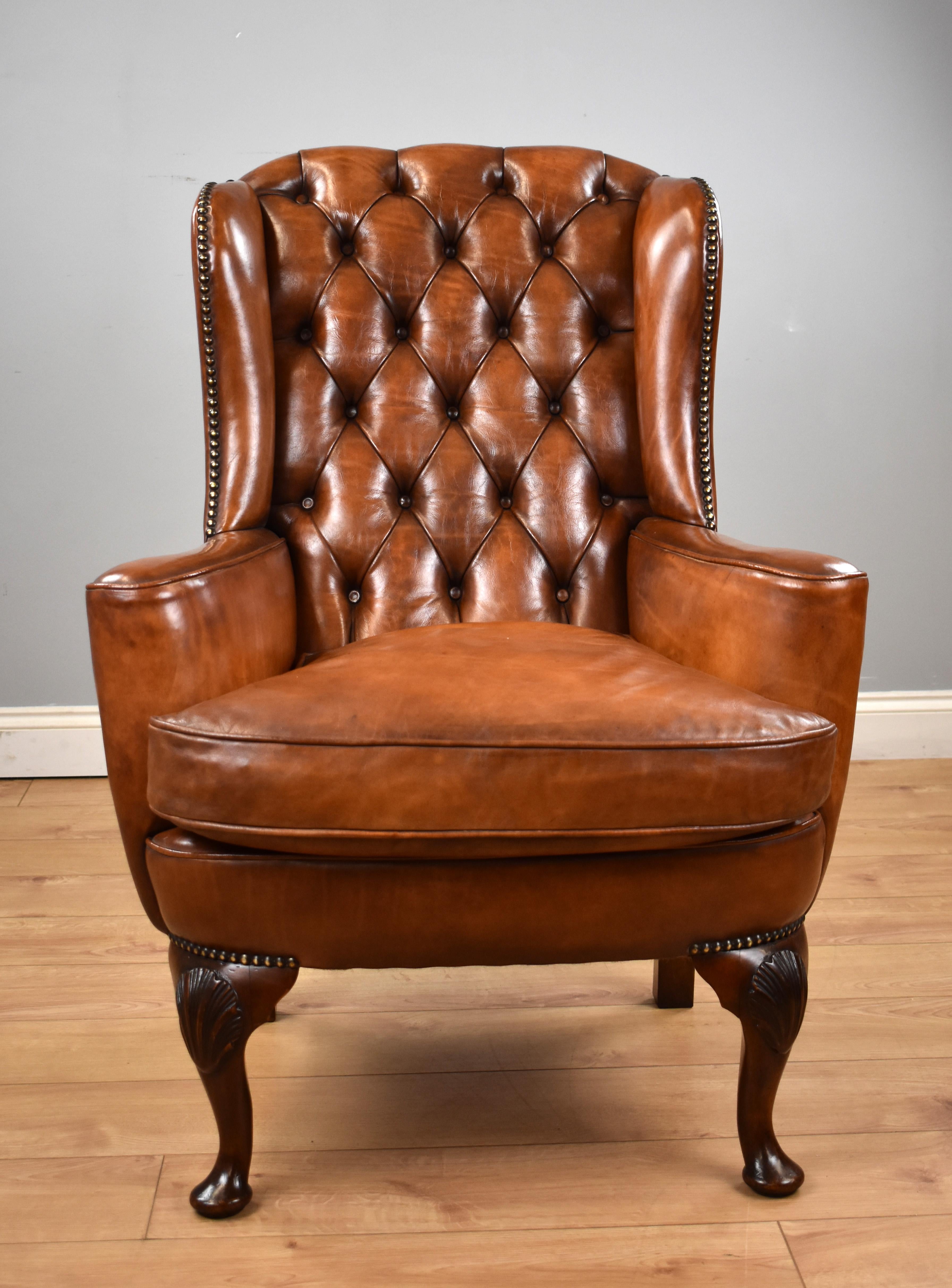 For sale is a good Victorian hand dyed leather wingback armchair, having a deep buttoned back flanked by a wing on either side, above a cushion with two sweeping arms. The chair stands on elegant cabriole legs with a carved shell on each knee and is