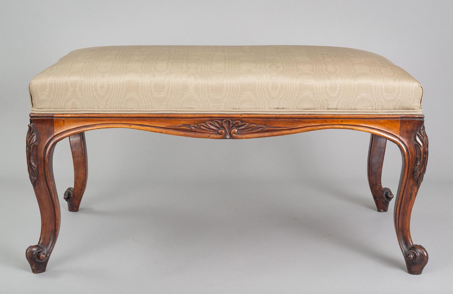 Carved rosewood bench with cabriole legs ending in French scroll feet. Upholstered in pale green silk moire.