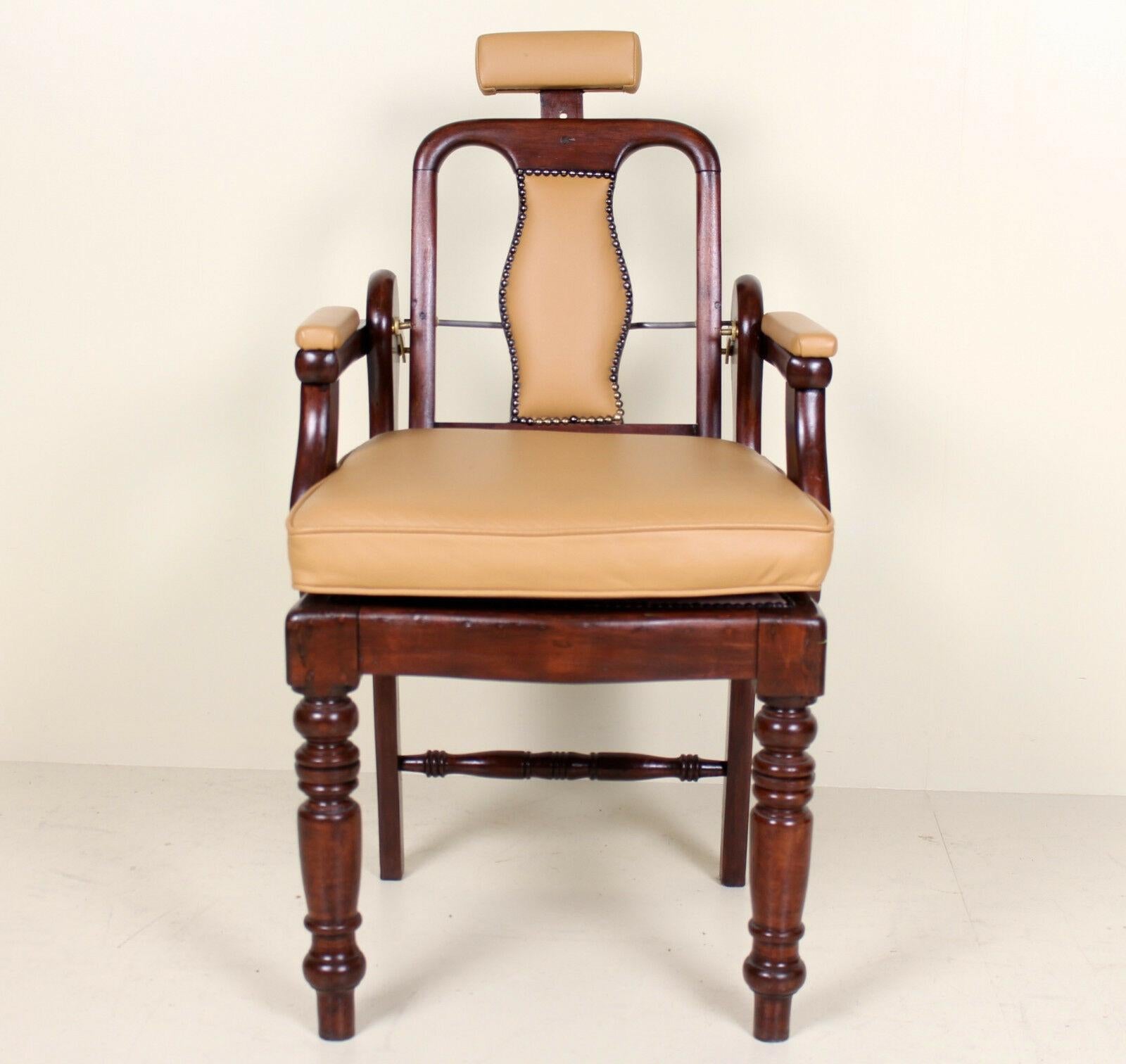 A rare opportunity to acquire an impressive Edwardian period (circa 1905) barbers chair. Framed in carved mahogany, with newly upholstered leather or leather cloth panels with studded brass borders. Raised on carved fluted turned legs.
  