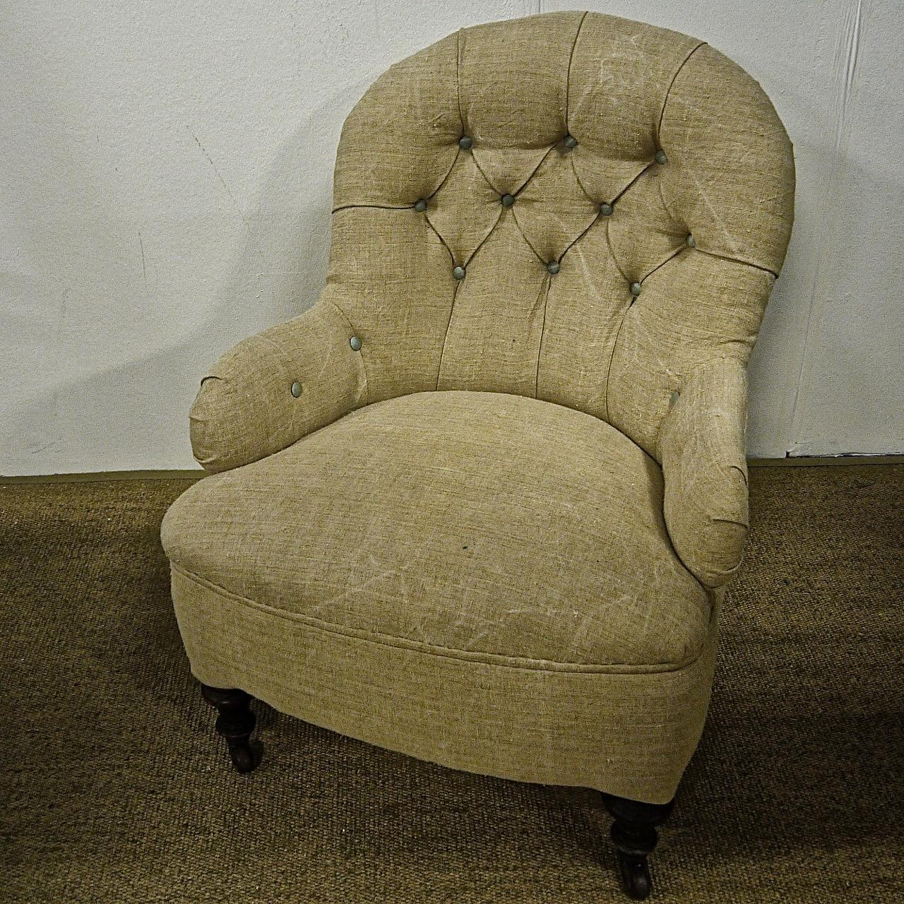 Elegant and comfortable English Victorian armchair newly upholstered in a 19th century French hemp textile with the buttoning highlighted in a pale blue 19th century French 'bourrette de soie' silk.With turned legs and its original castors.