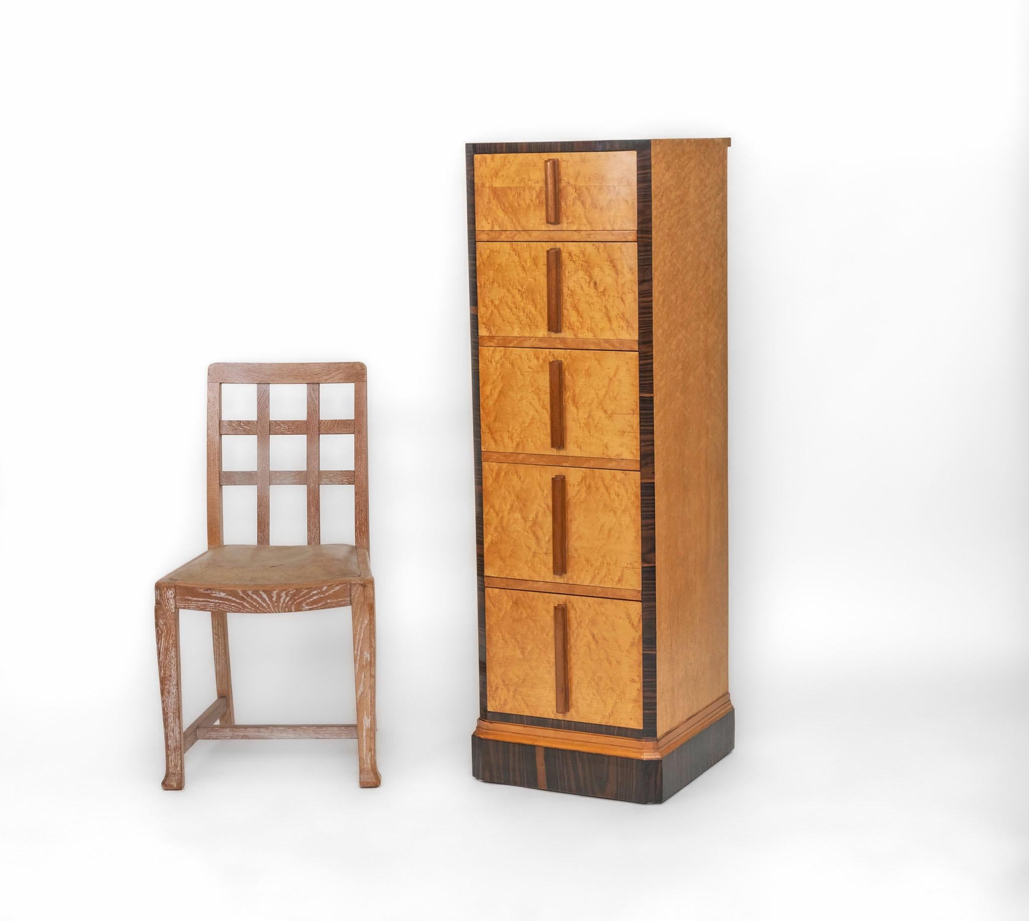 A striking Art Deco bird's eye maple & macassar ebony tall and narrow chest of drawers. English - 1930s.

The chest of drawers is of excellent quality and unusual streamlined size for this period. Compact and elegant in form, prioritising vertical
