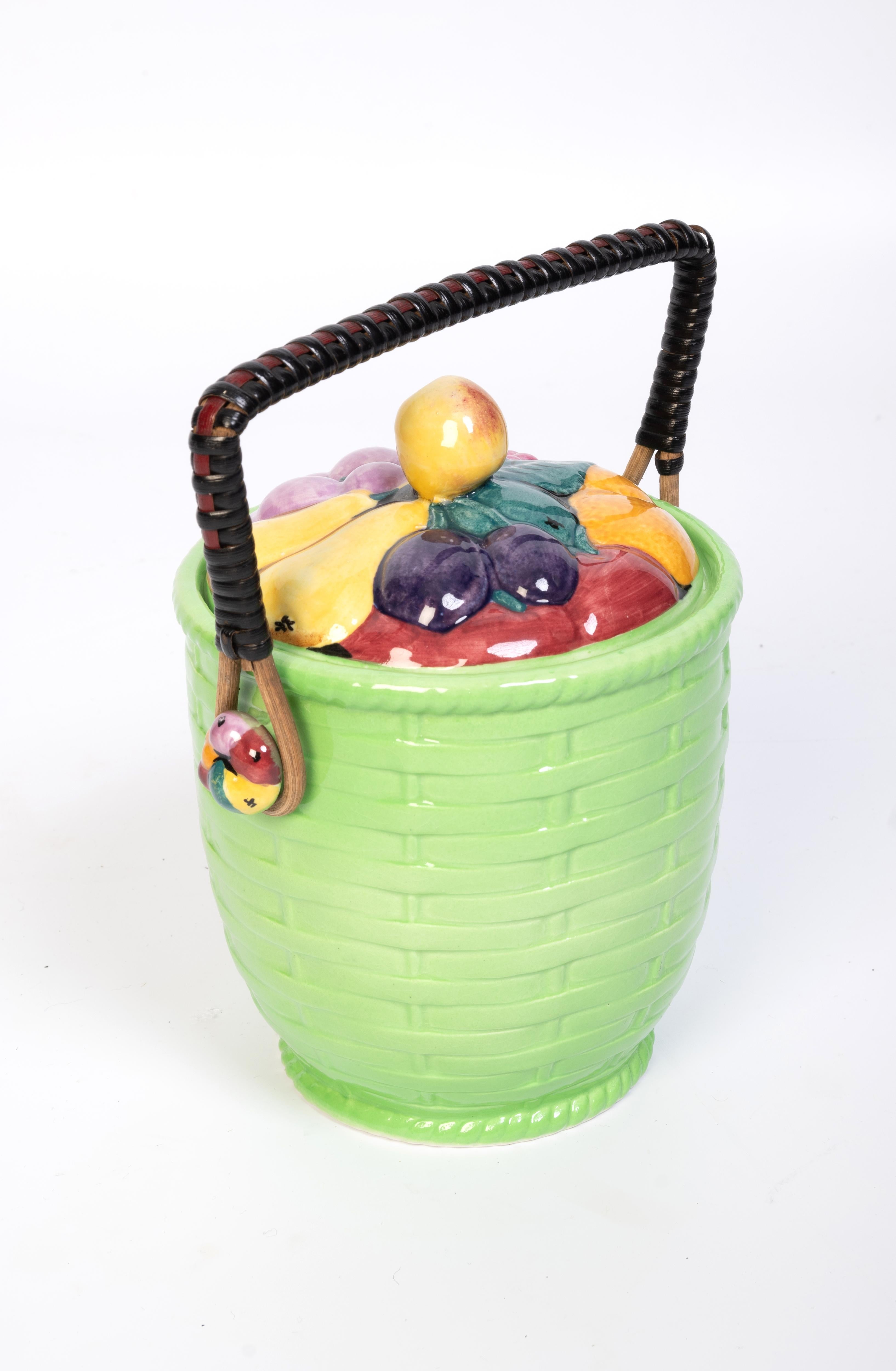 English Art Deco Biscuit Barrel Carlton Ware C.1930

Dimensions:

H20cm to handle
H18cm to top of lid
D13cm
W17cm

In very good condition. Minor chips to inside rim. colours bright and vibrant.