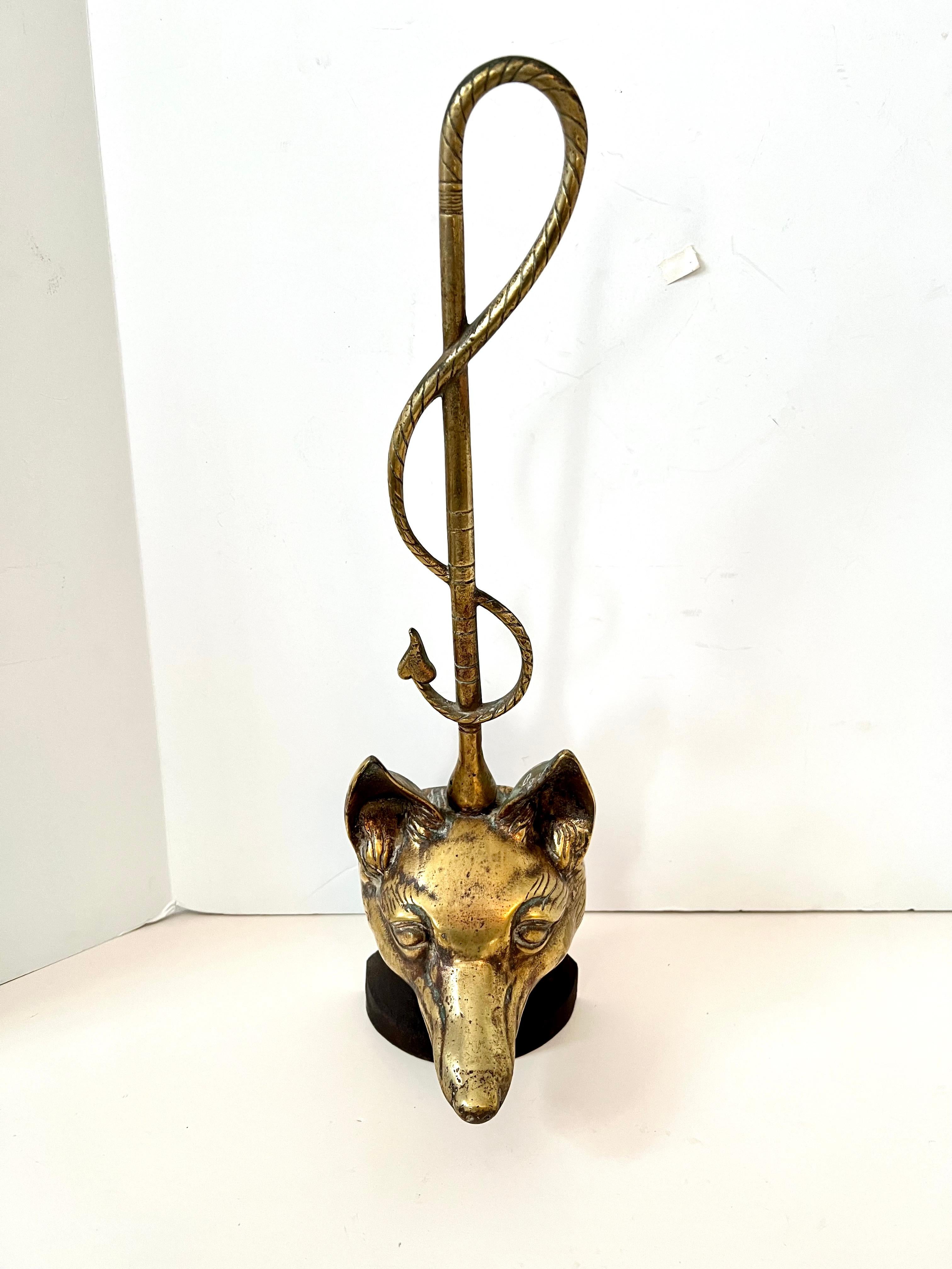 A beautiful nod to a classic English Figure - the Fox.  The fox door stop is made of brass and has, as a handle a lovely 'riding crop'.

Easy to pick up with out having to bend over too far - the piece is weighted with an iron base and back.   The
