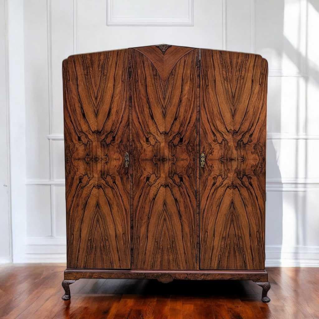 1930s English Burl Walnut Armoire with Bookmatched Veneer and Original Keys

This exquisite English armoire from the 1930s is a stunning example of craftsmanship and elegance. Made from beautiful Burl Walnut, this piece features a striking