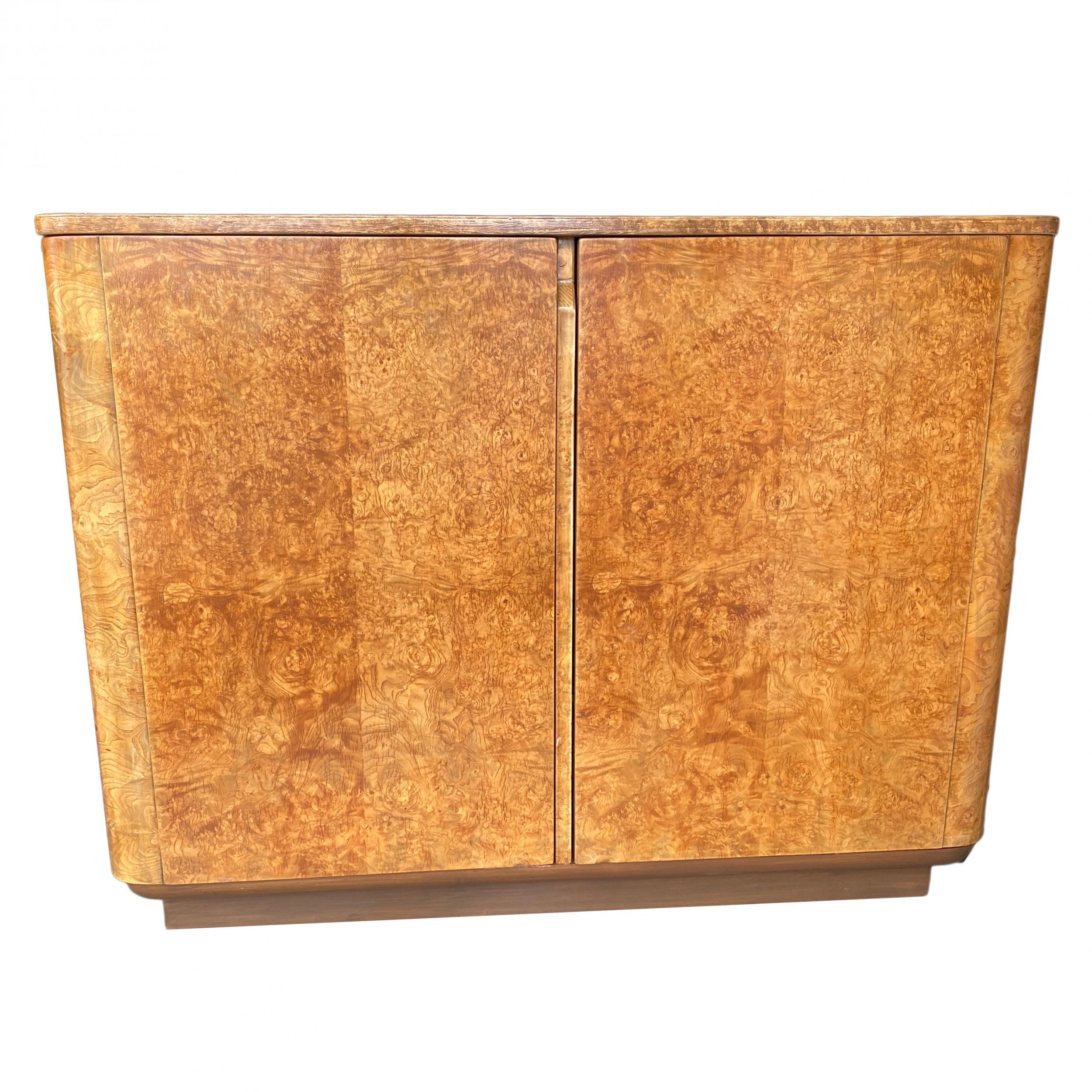 Original 1930s English Art Deco burl wood bedroom cabinet featuring 3 adjustable shelves and 2 adjustable drawers with tie holder attached to the door.
We have a pair available.