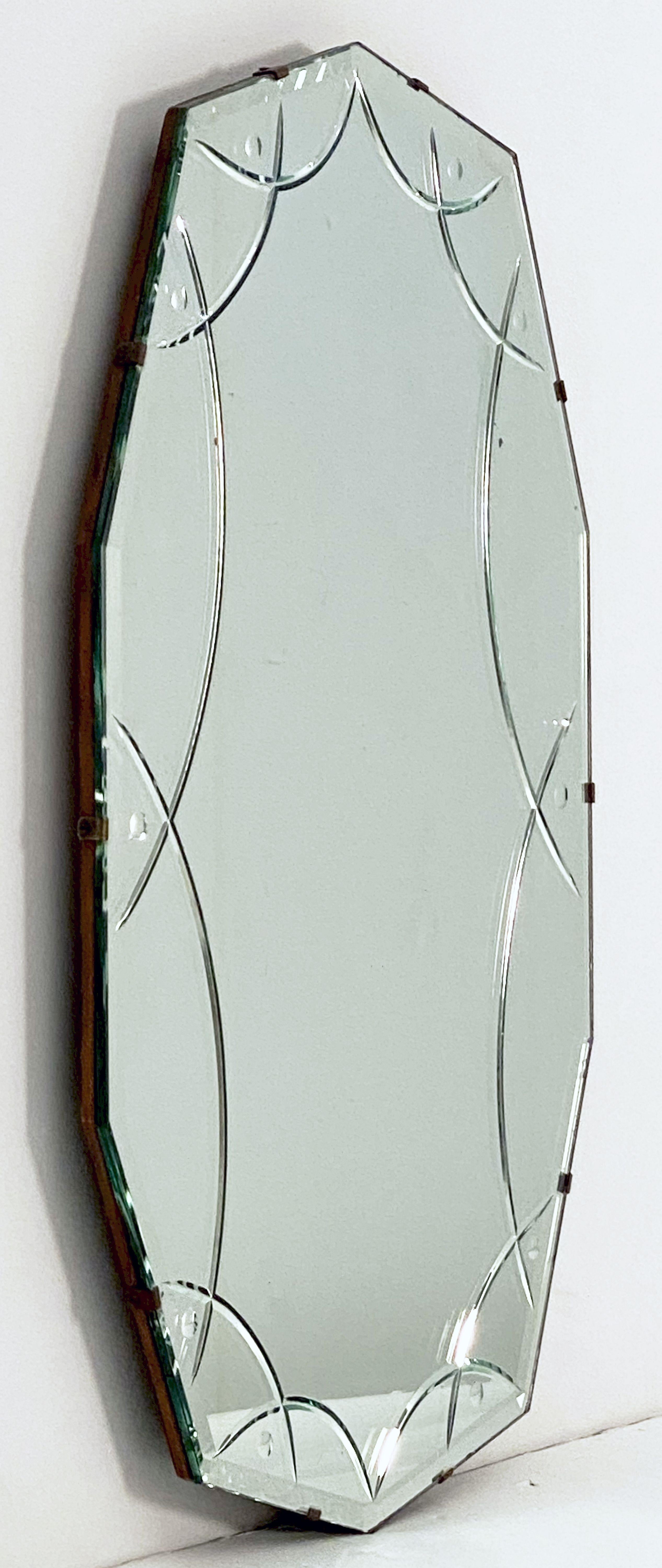 A fine vintage English decagonal or ten-sided oval beveled glass mirror from the Art Deco era featuring a reverse-cut design around the circumference.

With chain to back for vertical (portrait) display 25 1/2 inches x 15 3/8 inches.