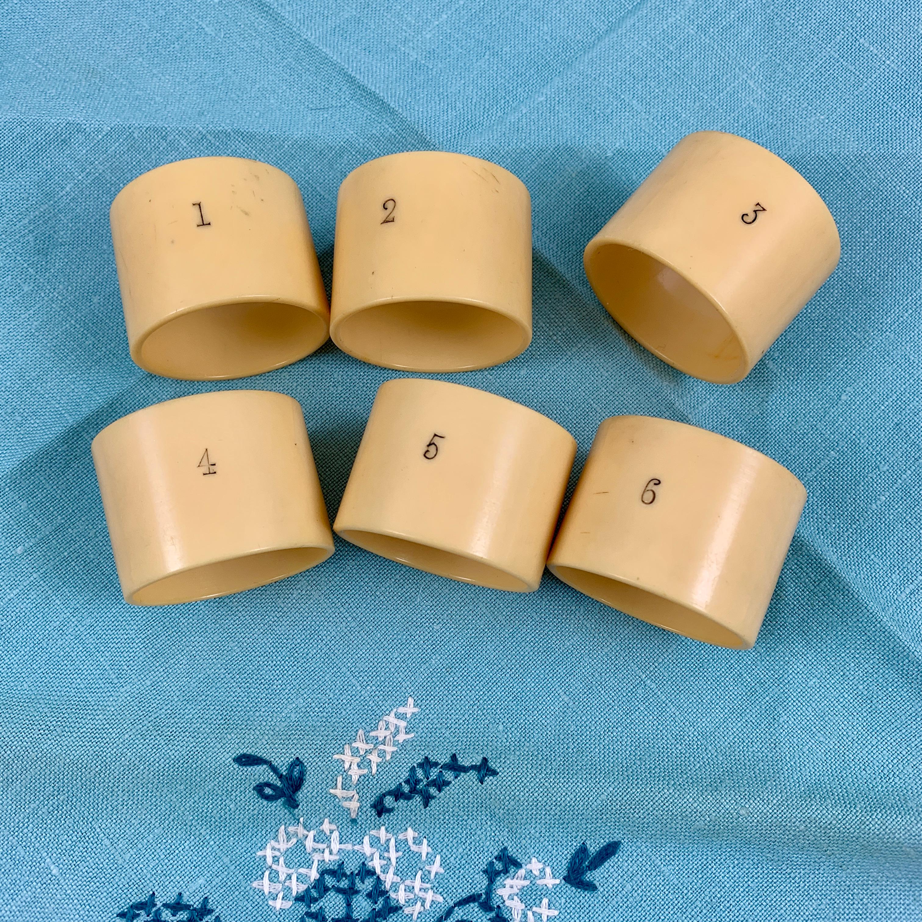 From the Art Deco era, a set of numbered napkin rings, England, circa 1920s.

Made of celluloid, often referred to as French ivory, the rings show the numbers one through six. The numbers are impressed into the celluloid and filled with black