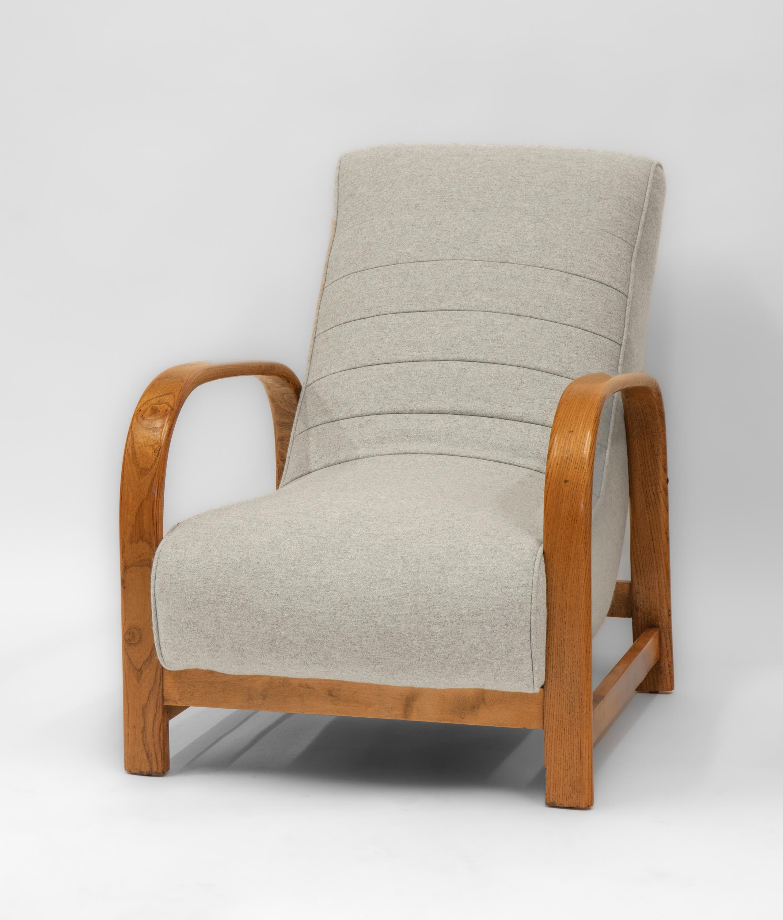 
A stylish Art Deco elm bentwood and beechwood framed lounge chair with Bute light grey wool upholstery. Circa 1930's.

Delivery is INCLUDED in the price for all areas in MAINLAND England & Wales. 

The bentwood arms show wonderful figuring to the