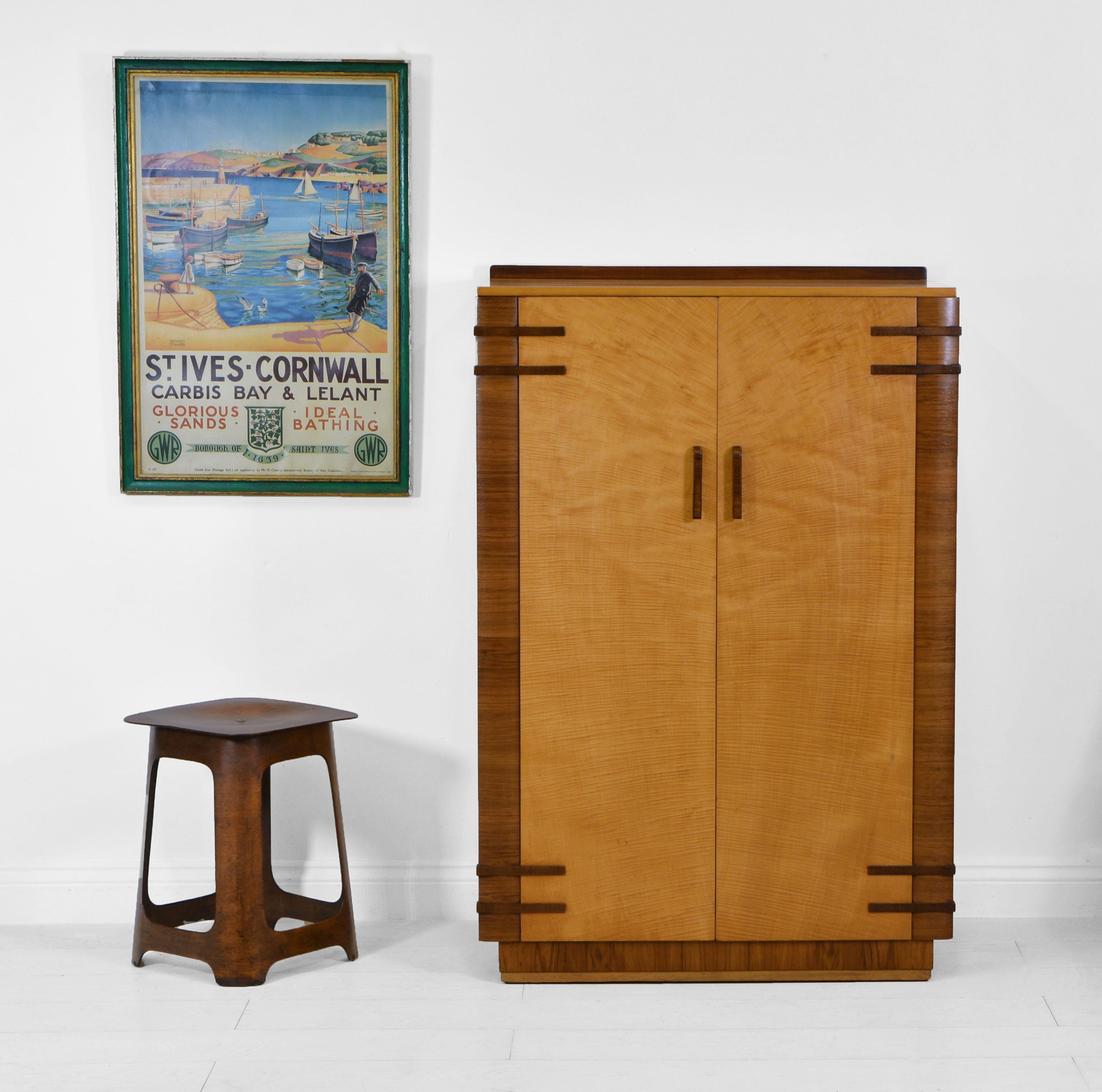 A stylish English Art Deco maple and contrasting walnut compact wardrobe/tallboy. Circa 1930.

*Free delivery for all areas in mainland England & Wales only. Delivery to room of choice by a two person team. Items are left packed. Return costs are