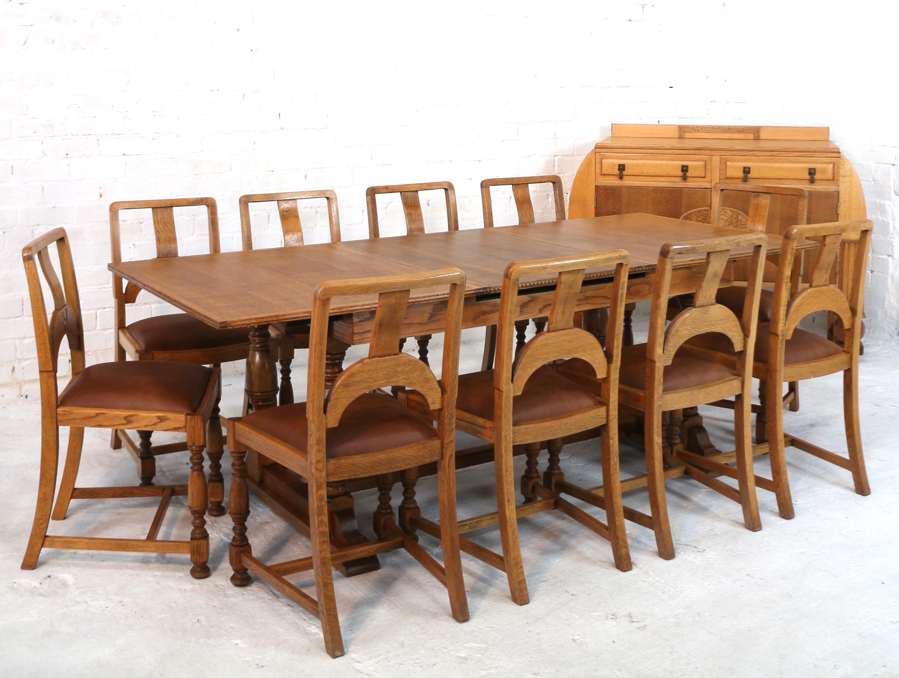 A stylish Art Deco twelve piece oak dining suite dating to the 1930s and comprising a draw leaf dining table, ten chairs and a sideboard. All in solid and veneered golden quarter-sawn oak the dining table is in the refectory style extending by means