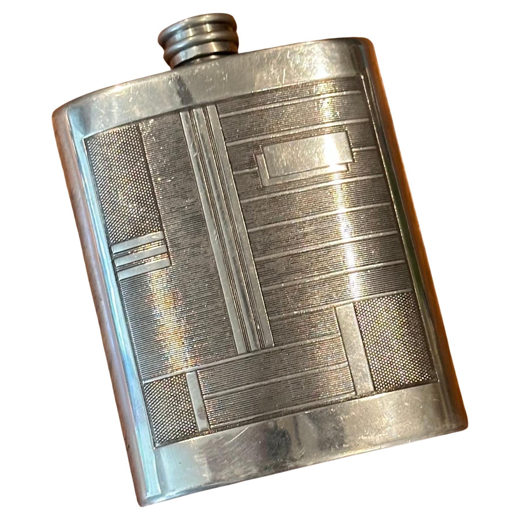 Extremely rare and sought after English art deco pewter flask with geometric pattern and beefeater marking on the underside, made in Sheffield, England, circa Edwardian period of the 1910s.  Sleek and elegant, it evokes the art deco style, clean