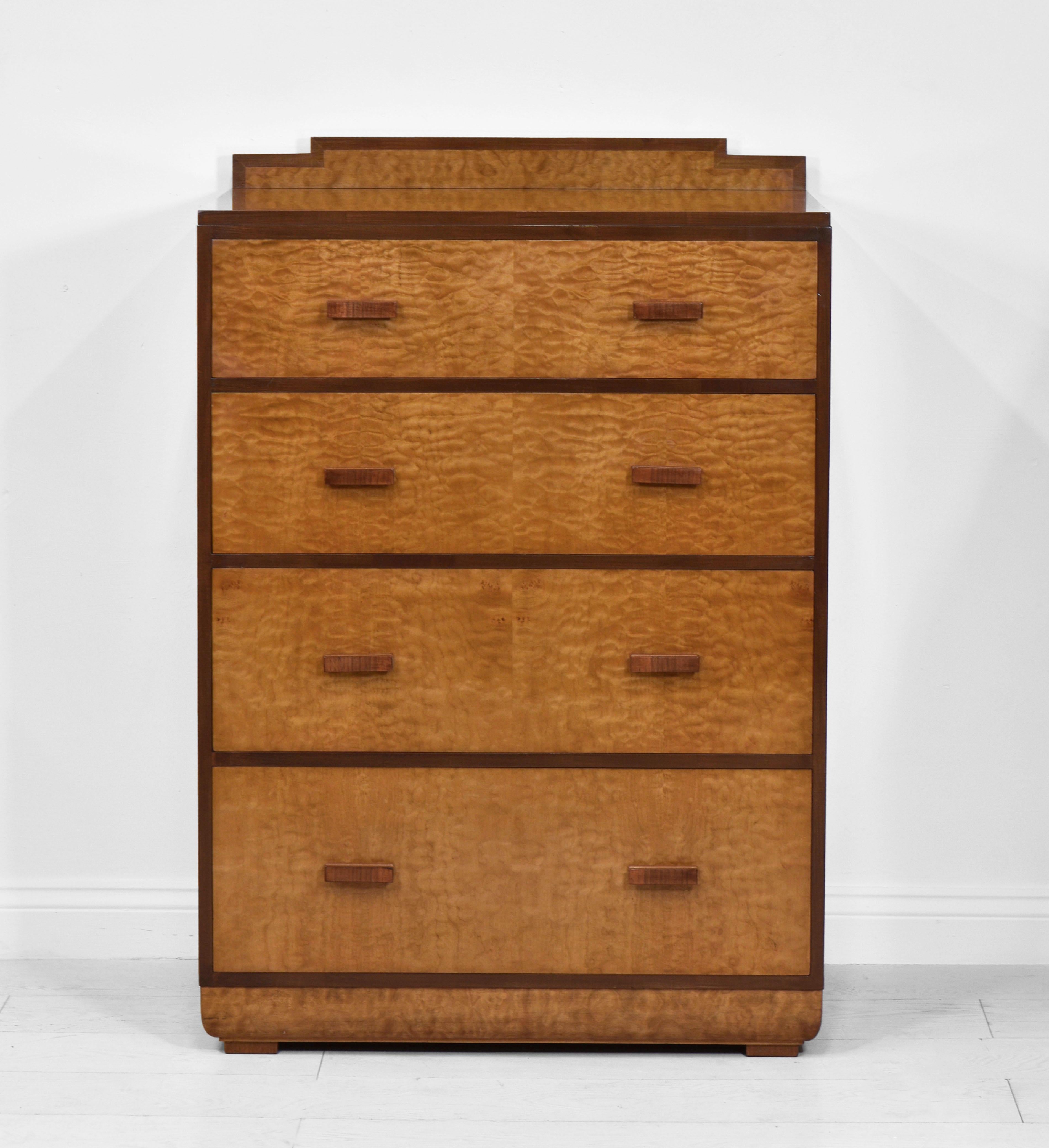 A superb Art Deco quilted maple and walnut chest of four graduating drawers, with step form back and inward swept plinth. Circa 1930.

The chest is veneered in quilted maple - a rare and beautiful veneer from the big leaf maple trees of the