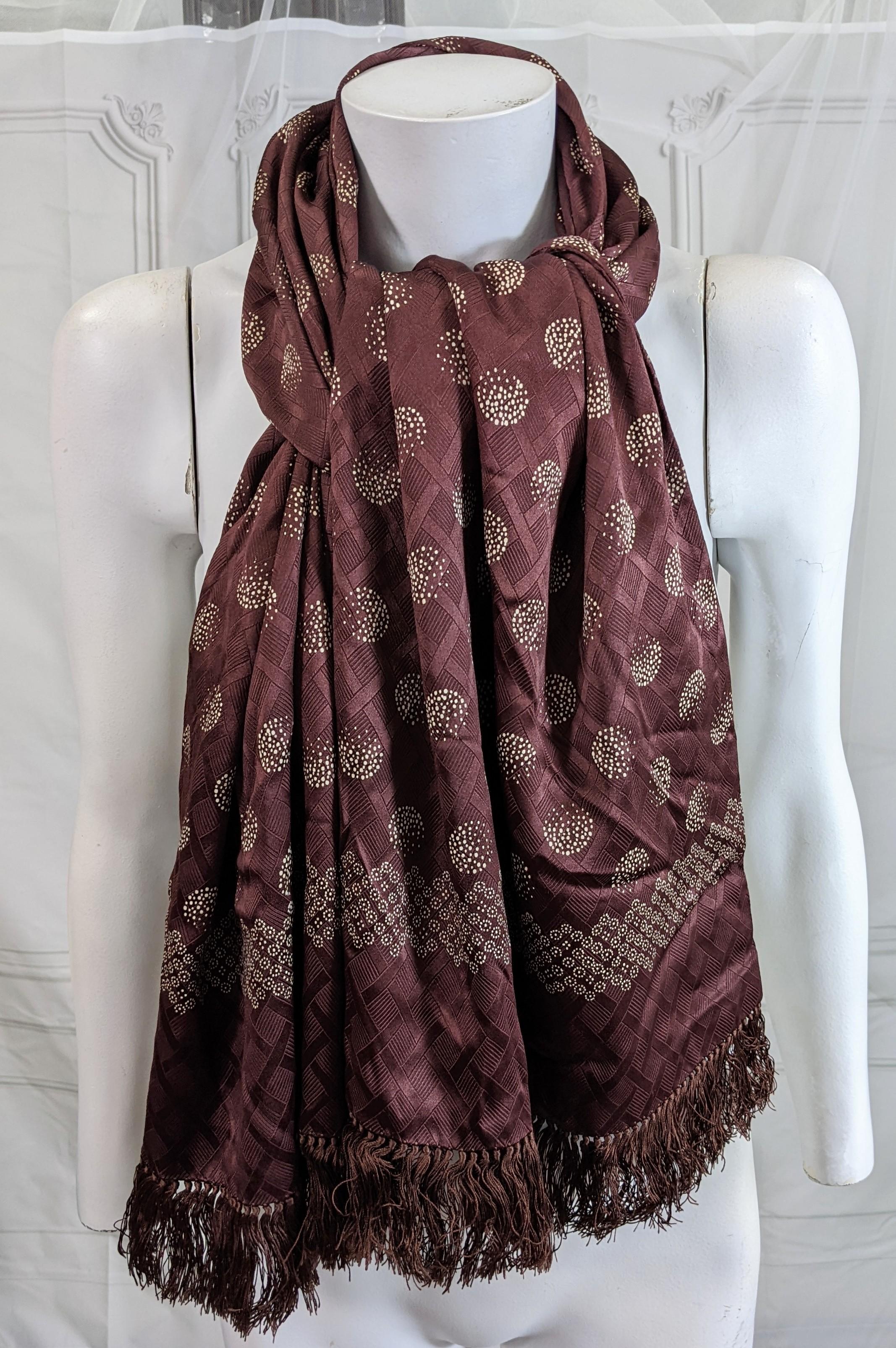 Large, luxurious Art Deco Silk Crepe Print Muffler imported from the UK for Saks Fifth Ave, NY circa 1930. Very rich doubled silk crepe is adorned with hand fringe on ends. A subtle globe print on a jacquard grid base pattern. 
58