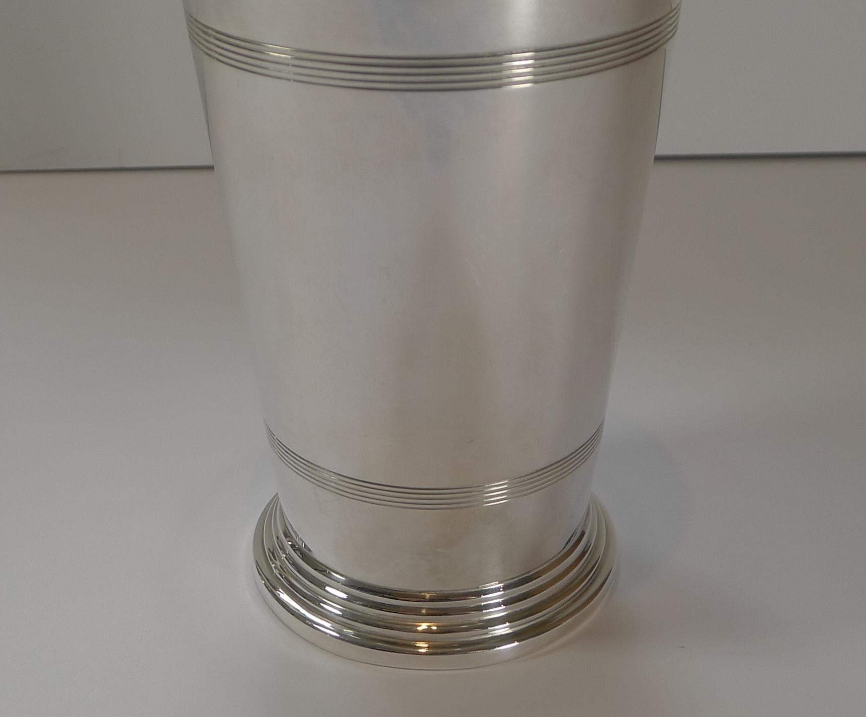 A particularly good and unusual of an Art Deco silver plated cocktail shaker; a fabulous shape and look. 

The top comes off to reveal a plug to the top which once removed reveals the strainer which can then be removed.

Lovely quality, the