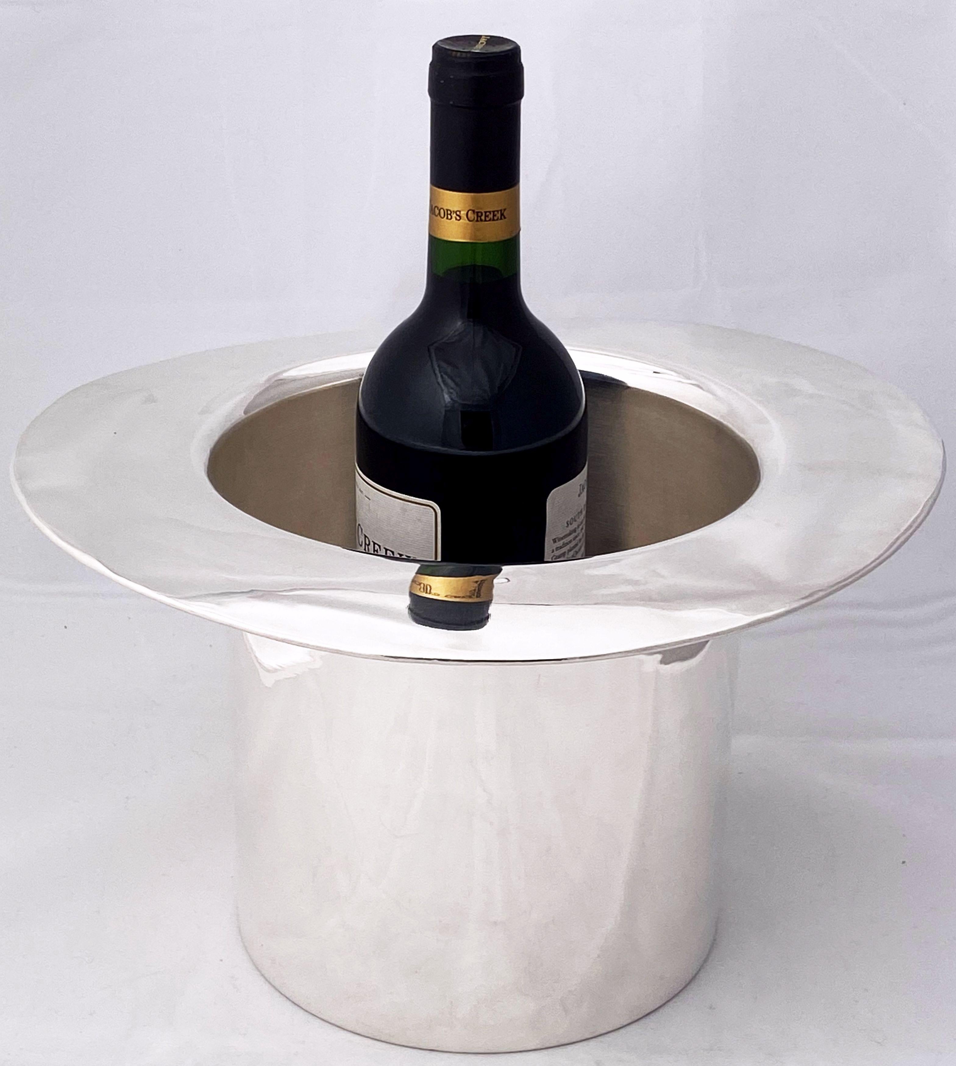 A dapper Art Deco era champagne bucket or wine cooler of fine plate silver in the elegant shape of a gentleman's top hat by the celebrated English silversmiths, Mappin and Webb. 

The top hat is the size of an authentic chapeau and is marked