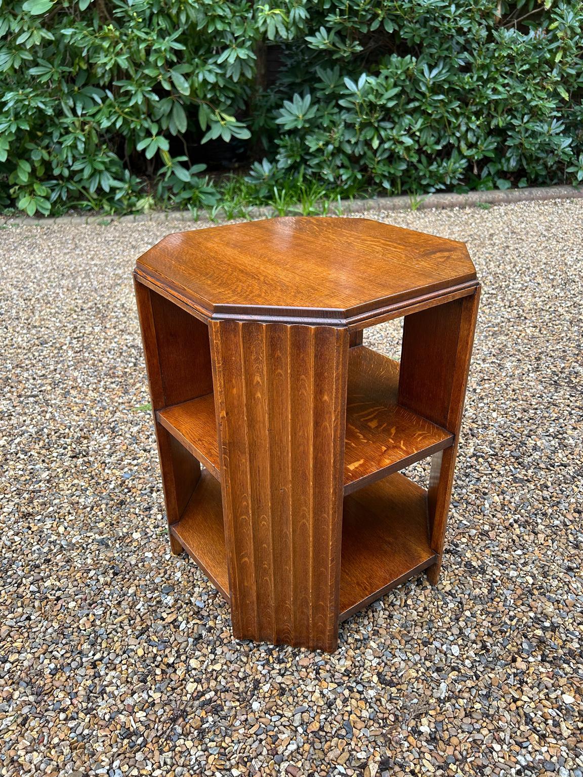 A very high quality English Art Deco Solid Oak Octagonal Book / Coffee Table with carved fluted panels to each of the four corners. Has two shelves below the table top ideal for books or magazine storage.

Circa: 1920’s

Video: If you require video.
