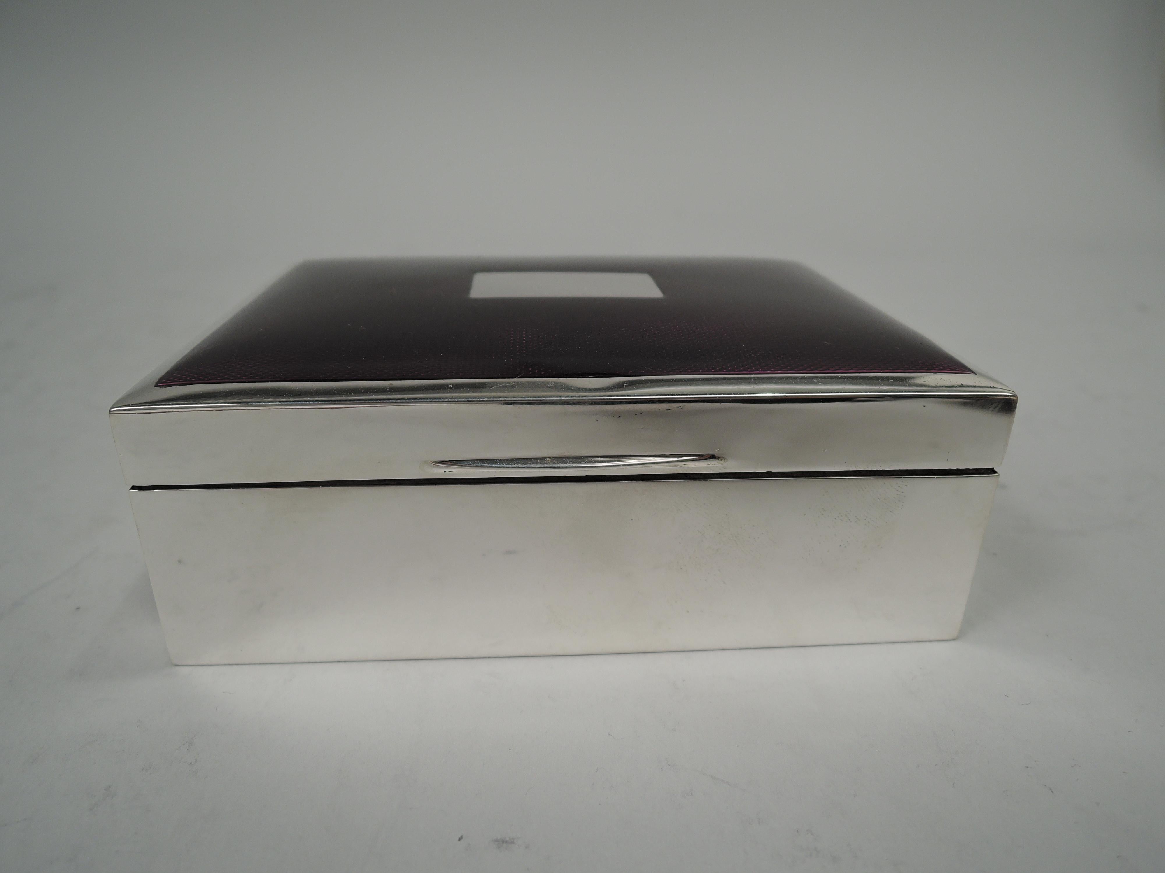 Art Deco sterling silver and enamel box. Made by Harman Brothers in Birmingham in 1972. Rectangular with straight sides. Cover hinged and tabbed; top gently curved with rectangle (vacant) surrounded by purple guilloche enamel. Interior cedar lined.