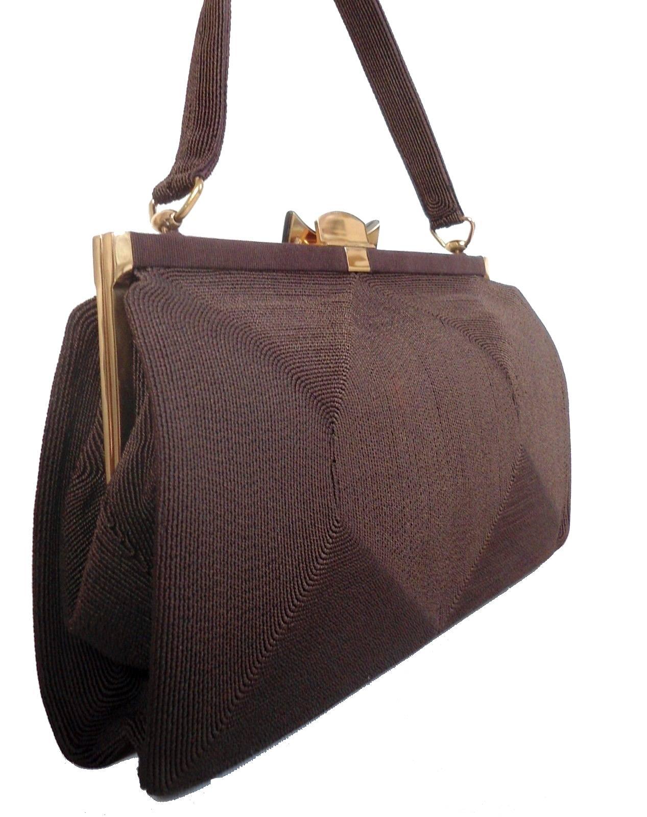 For your consideration is this wonderfully stylish English handbag made from cord with a Lucite and chrome clasp. This is a totally authentic bag in a wonderful Art Deco shape which dates to the late 1930s-1940s. The interior is lined in a plum silk