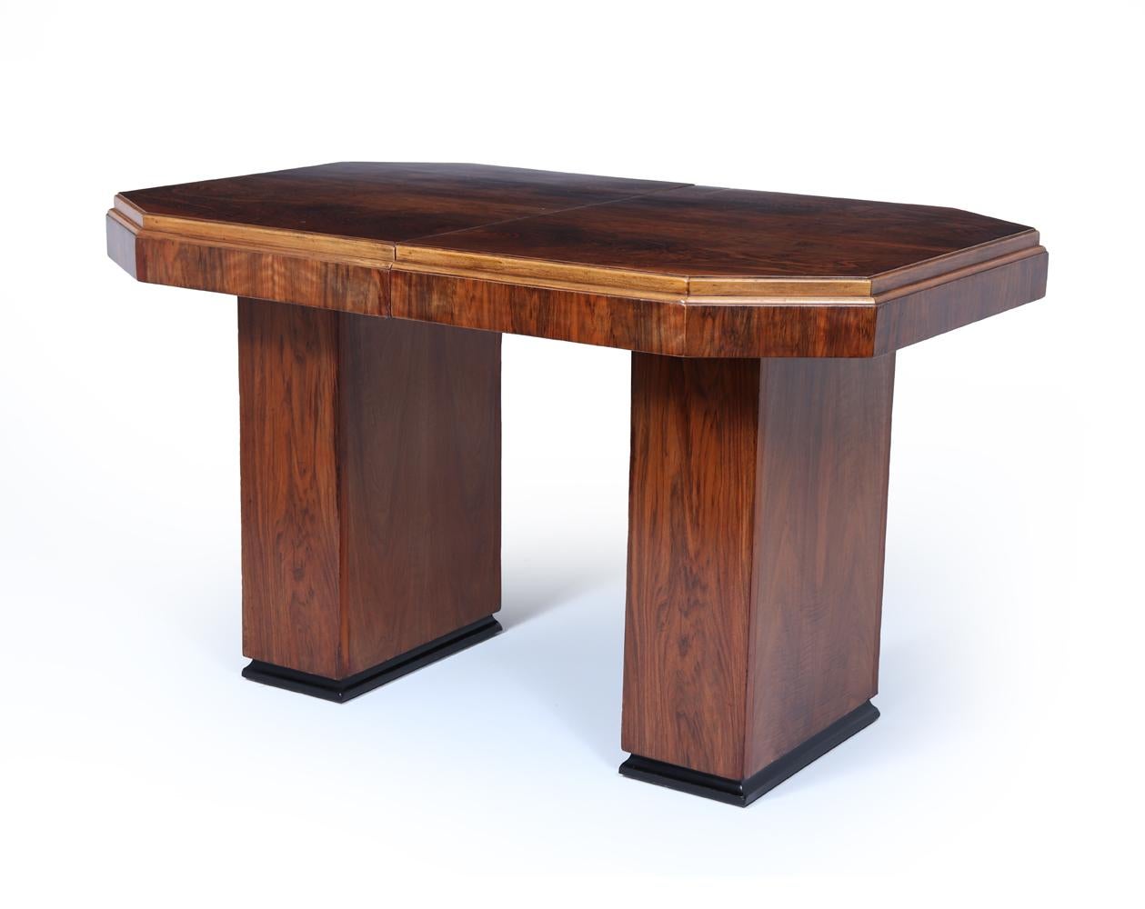 Art Deco Dining Table
A beautifully proportioned English Art Deco dining table, crafted in richly figured walnut and raised on twin pedestal bases with ebonised plinths. Compact in form yet elegantly substantial, the table features a clever