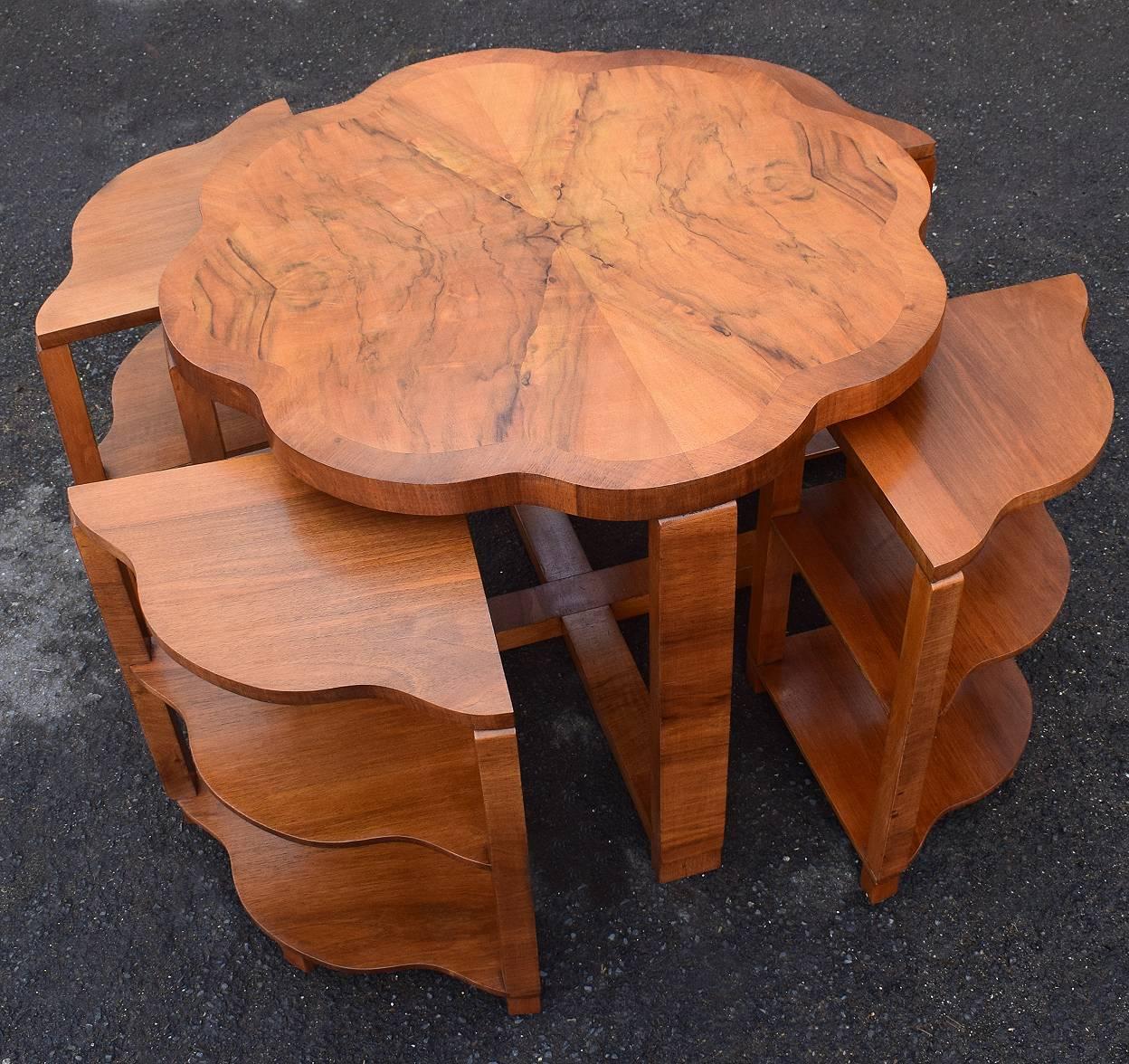 A very stylish 1930's Art Deco nest of tables by Harry & Lou Epstein. The set comprises one large centre table with scalloped edges and four, three tiered triangular inserts with the most exquisite warm walnut veneers. The four pull out side tables