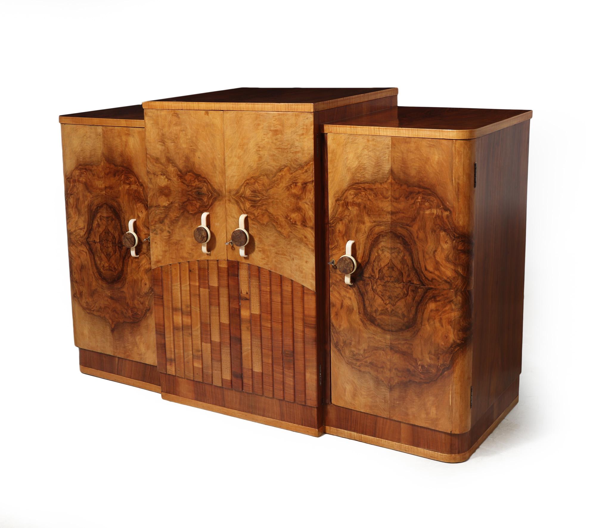 ART DECO WALNUT SIDEBOARD
Transport yourself back to the glamour of the 1930s with this stunning Art Deco sideboard from England! Crafted in luxurious figured walnut, this piece exudes elegance and sophistication. The reeding detail on the lower