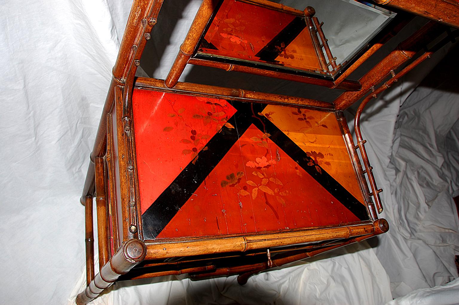 English Art Nouveau period bamboo and lacquer dressing table with shelves, mirror and central drawer. The hand painted lacquer surface is quintessential Art Nouveau with birds and leaves in the Japanese manner and angular spaces of slightly
