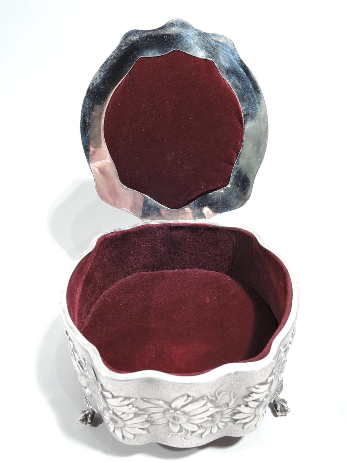 Edwardian Art Nouveau sterling silver box. Made by Levi & Salaman in Birmingham in 1904. Round and wavy form with straight sides and overhanging hinged cover. On cover top in voluptuous relief is scene of daisy divination inspired by Goethe’s Faust