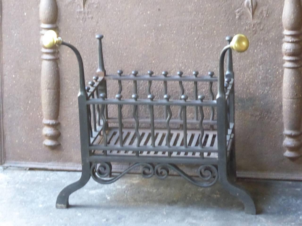 English Art Nouveau fire grate made of cast iron, wrought iron and brass. The total width of the grate is 62cm and the width of the basket itself is 43.5cm.

We have a unique and specialized collection of antique and used fireplace accessories