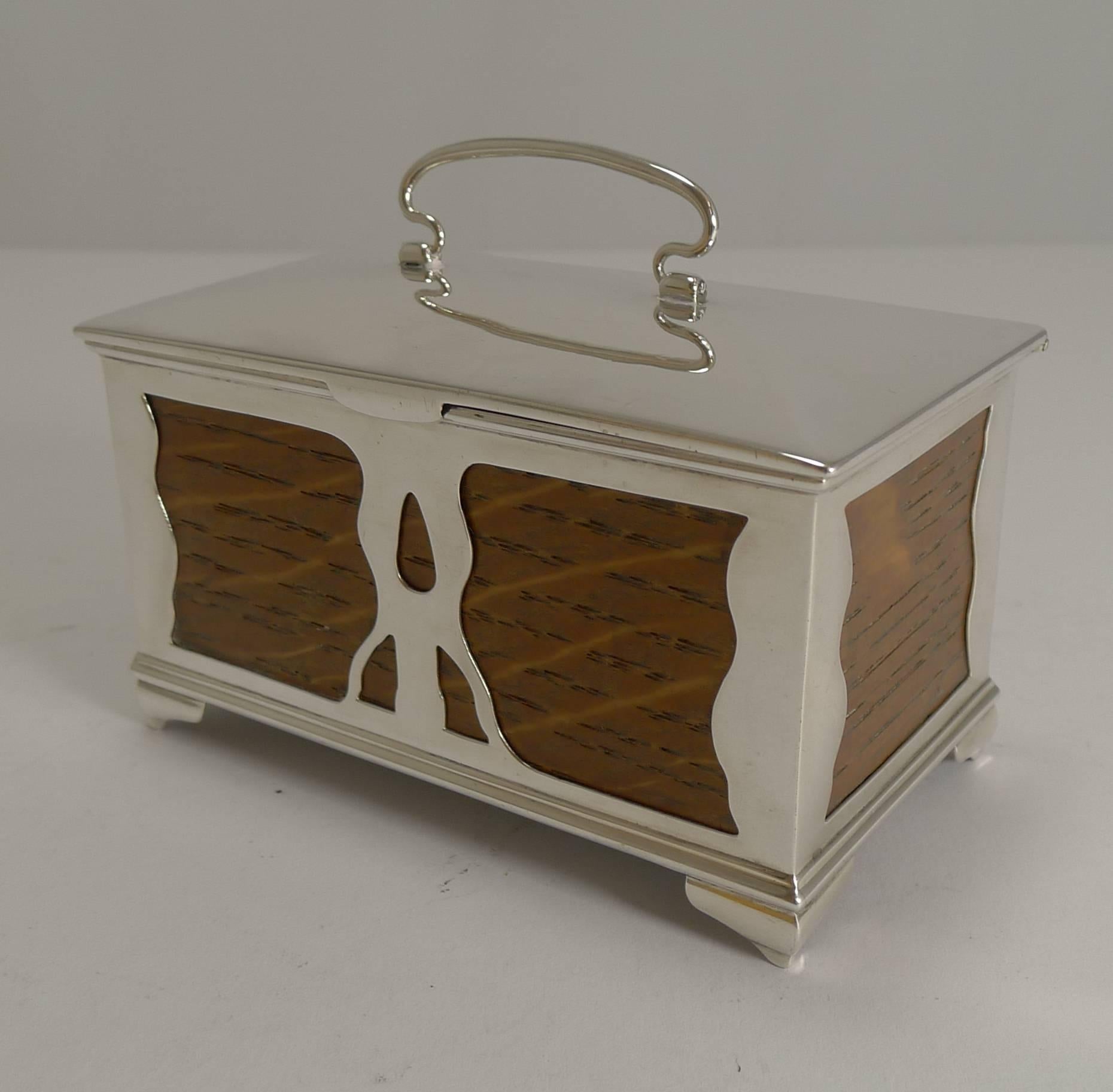 A magnificent Art Nouveau trinket box made from solid English oak and mounted with sterling silver.

Standing on four little feet, the underside is where the full English hallmark can be found for Birmingham 1904 together with the makers initials